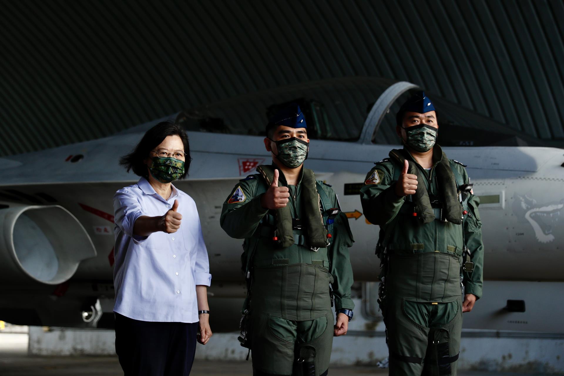 Taiwan's President Tsai Ing-wen (L) poses next to Air Force pilots during her visit to Penghu, Taiwan, 30 August 2022. EPA-EFE FILE/RITCHIE B. TONGO