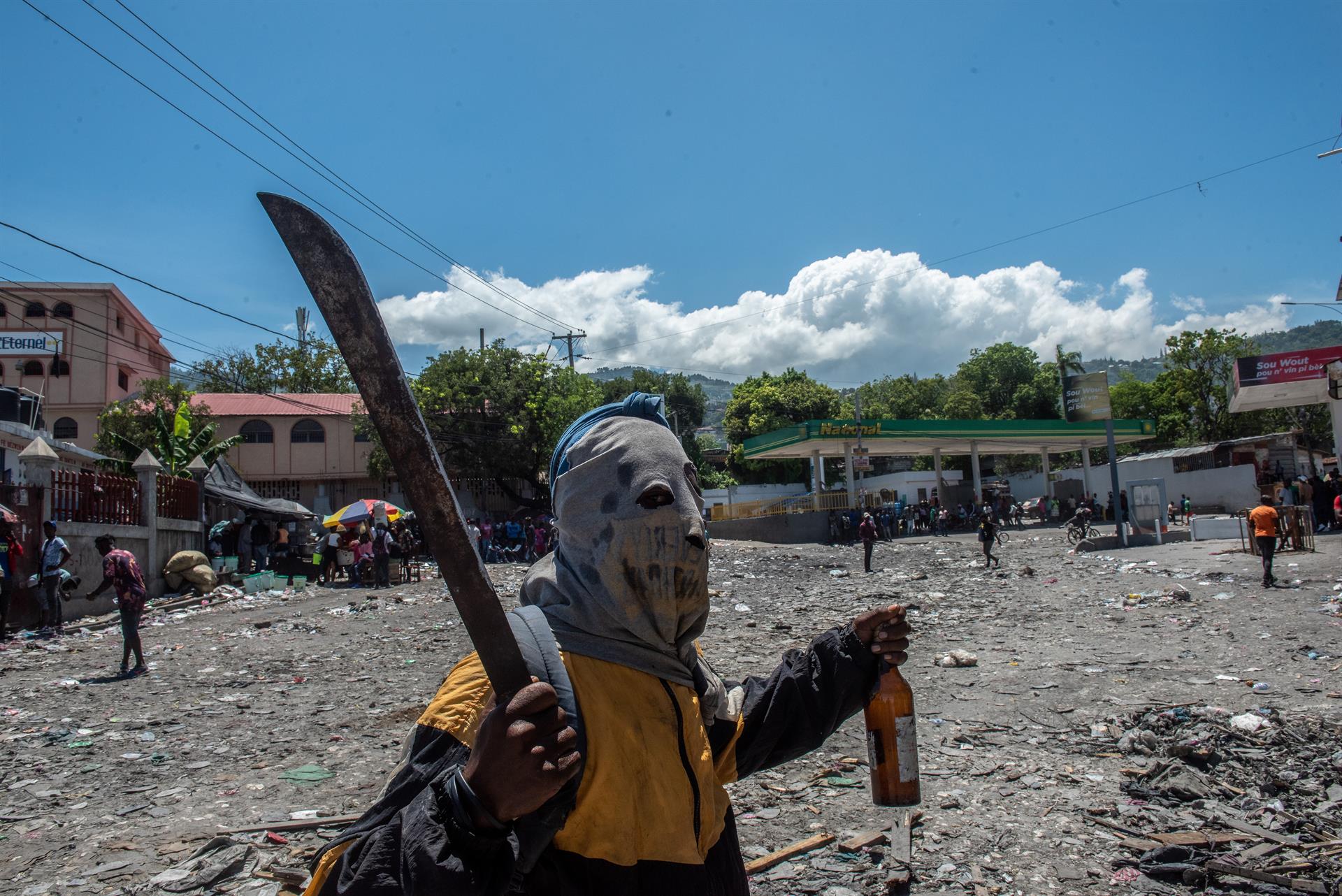 A demonstrator holds a machete during a protest in Port-au-Prince, Haiti, 15 September 2022. EPA-EFE/Johnson Sabin