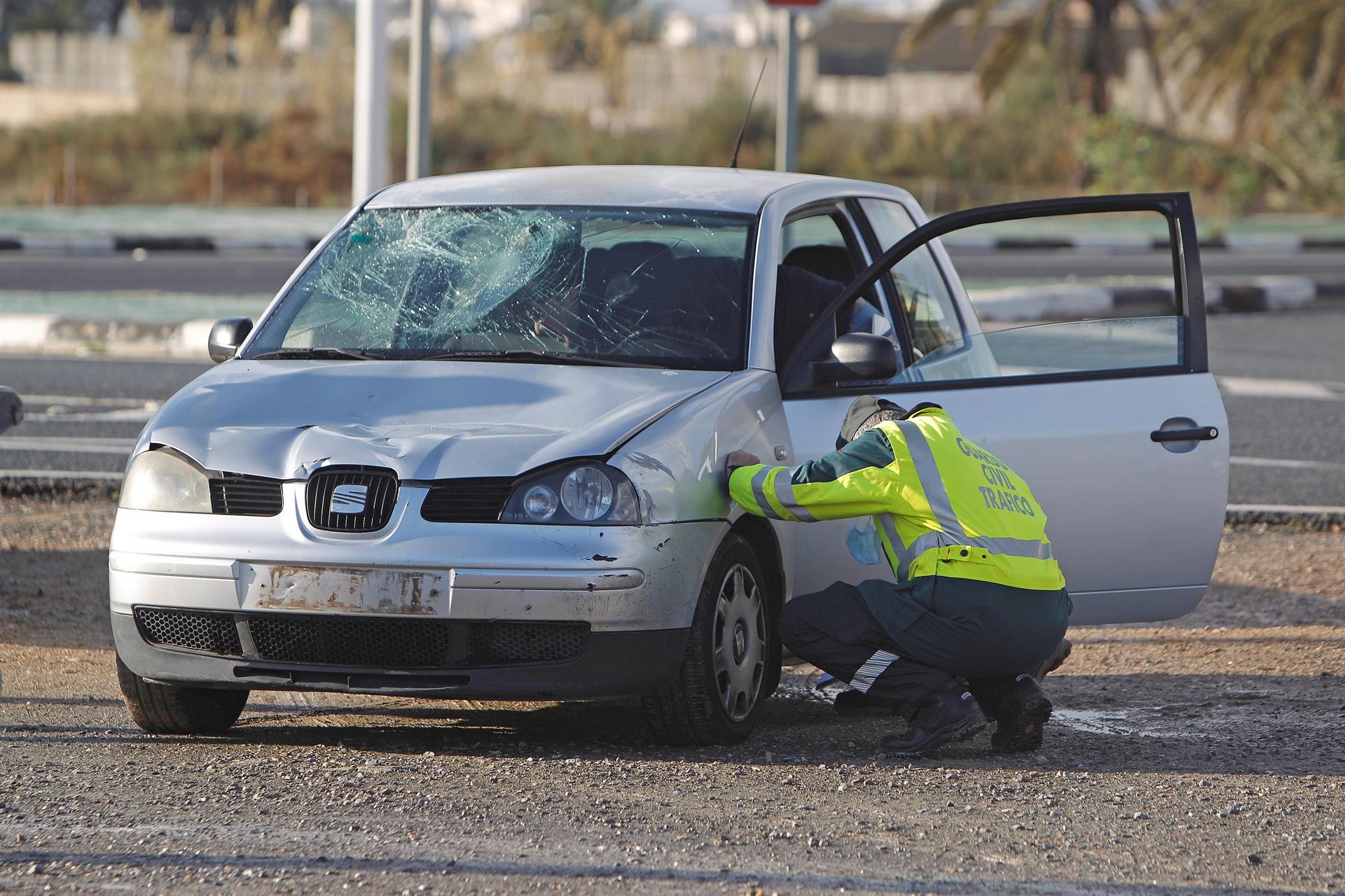 Un agente de la Guardia Civil de Tráfico revisa un vehículo involucrado en un accidente. EFE/Morell/Archivo