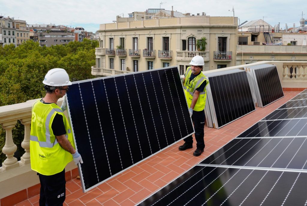 Varios trabajadores instalan placas solares en Barcelona