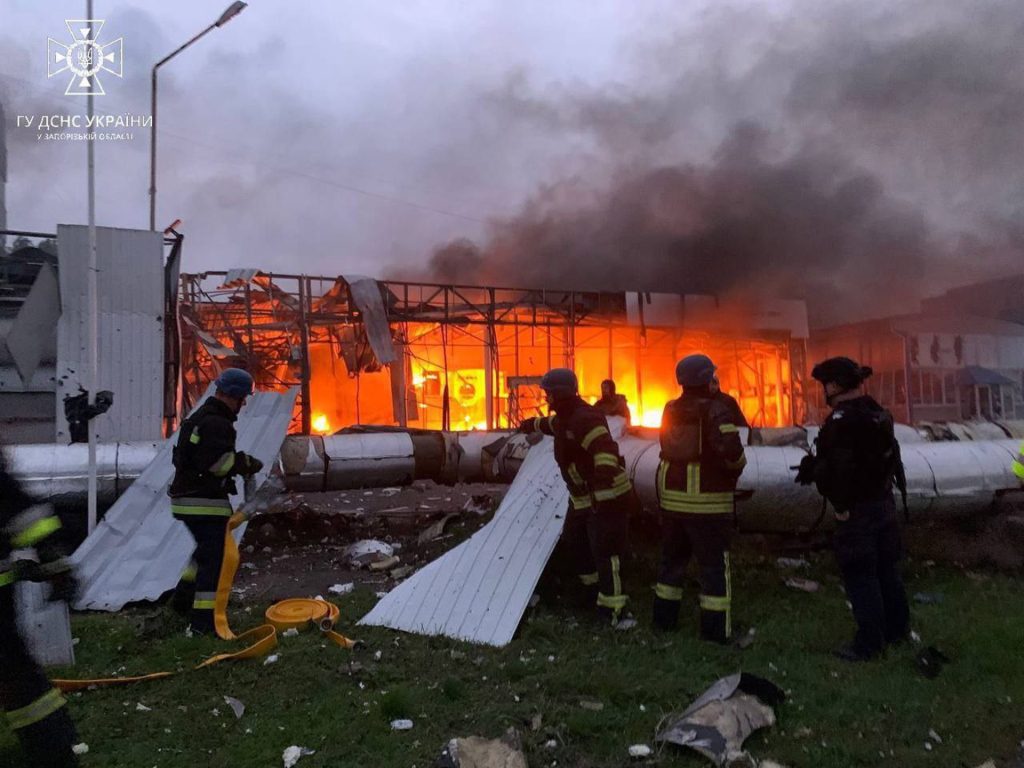 Imagen facilitada por el Servicio Estatal de Emergencia de Ucrania que muestra a un grupo de rescatistas extinguiendo un incendio desatado tras el ataque con misiles en Zaporiyia. 