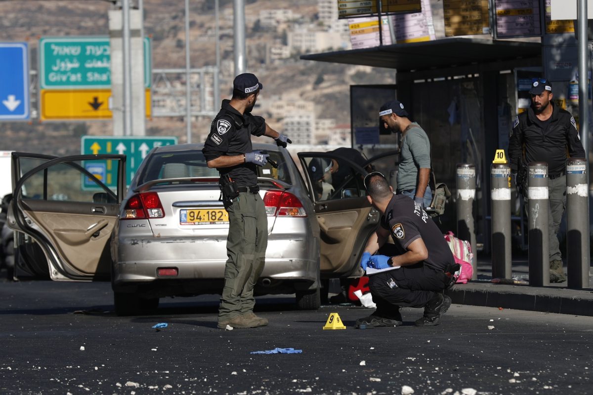 Las fuerzas de seguridad israelíes recogen fragmentos en uno de los escenarios de las explosiones registradas este miércoles en Jerusalén.