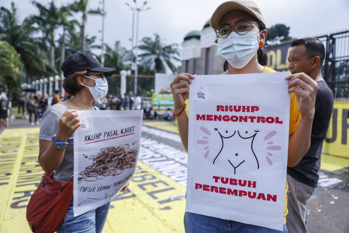 Un manifestante sostiene un cartel que dice "La ley penal controla el cuerpo de la mujer" durante una protesta frente al Parlamento en Yakarta contra la reforma del Código Penal.