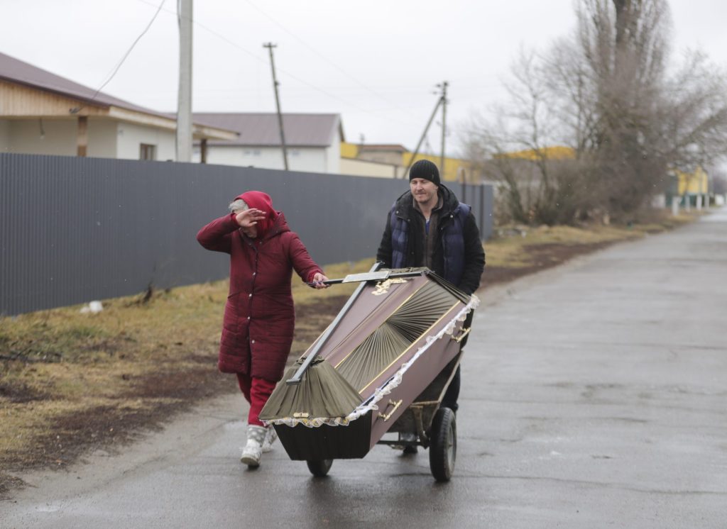 Dos personas trasladaban un ataud tras un bombardeo en la ciudad de Borodyanka cerca de Kiev, en marzo de 2022. 
