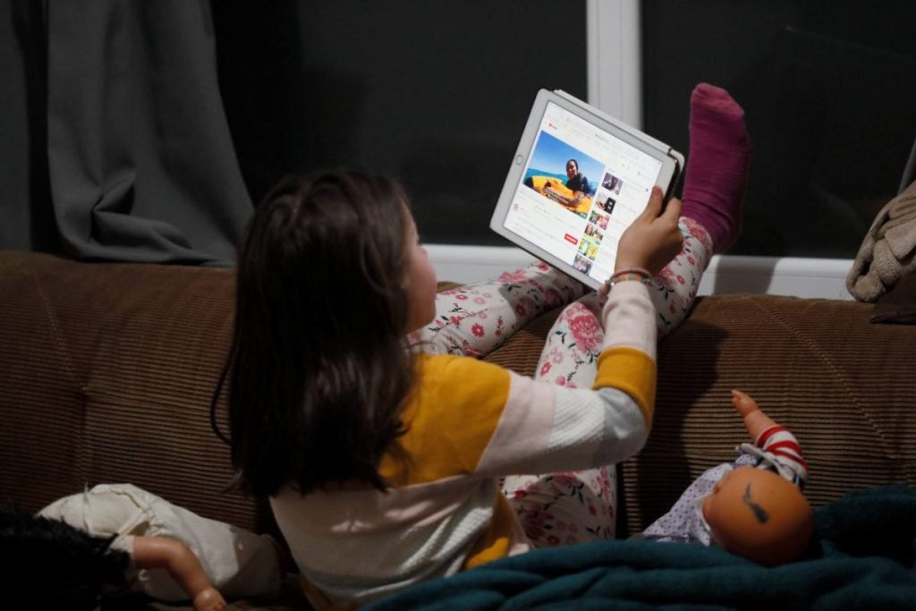 A girl plays with her tablet, in a file image.  Today is Safer Internet Day