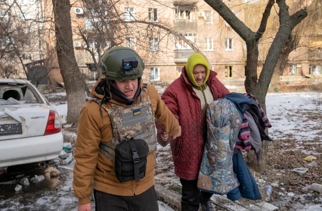 Mykola evacua a Valentyna, una mujer local de 72 años, de su casa en Bajmut, Ucrania.
