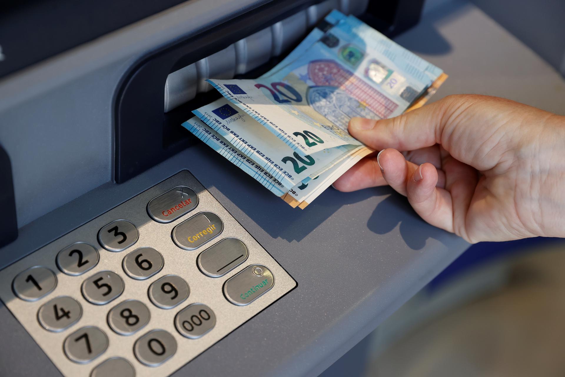 Una persona saca dinero de un cajero de una entidad bancaria. EFE/Emilio Naranjo/Archivo