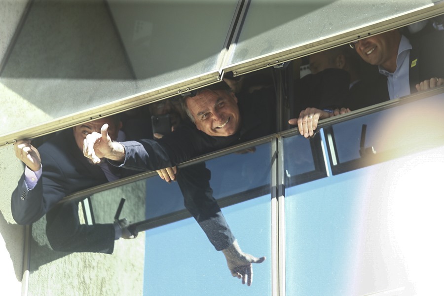 El expresidente brasileño Jair Bolsonaro saluda desde una ventana en la sede de su partido este jueves en Brasilia (Brasil)