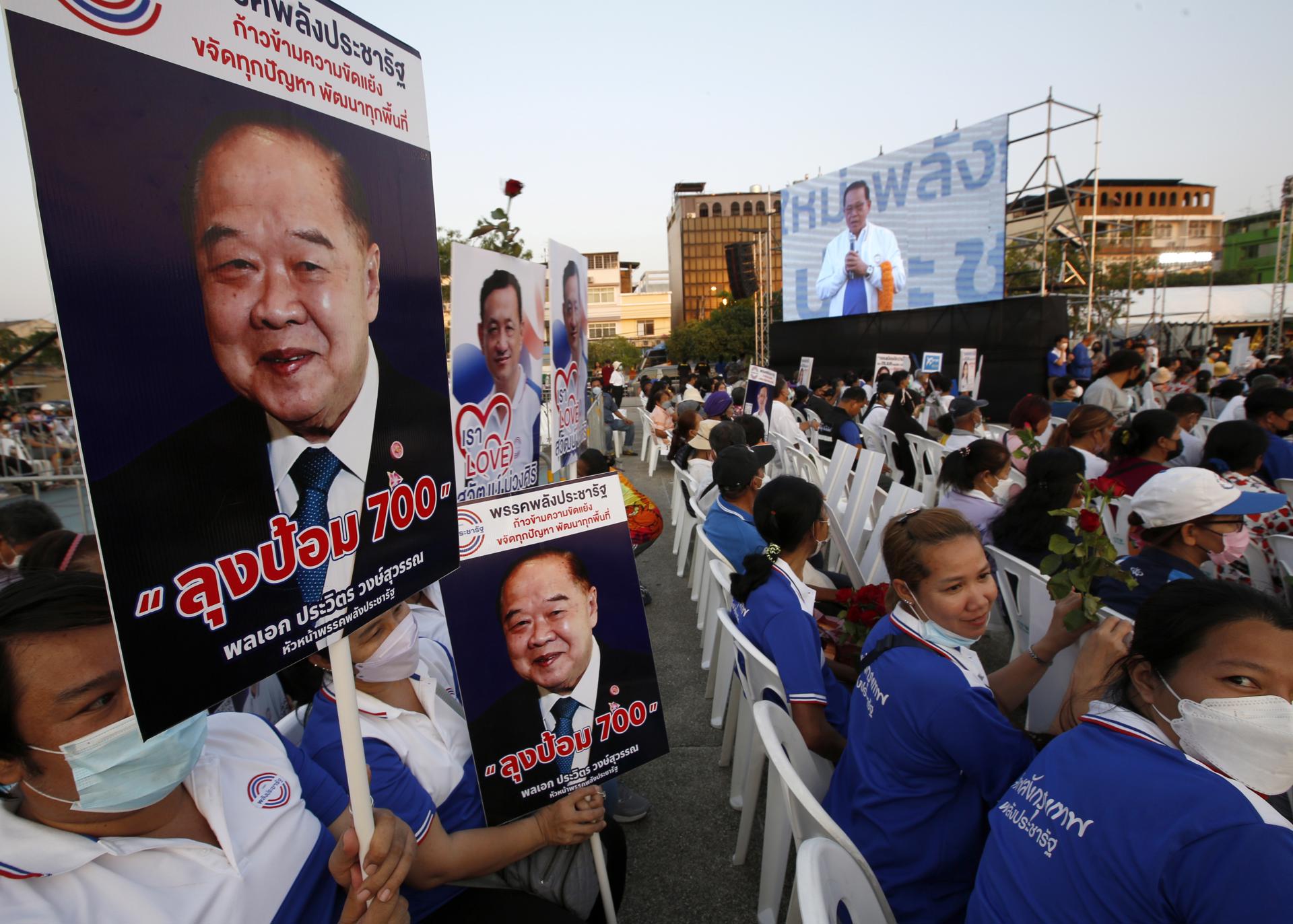 Supporters hold pictures (L) of Thai Deputy Prime Minister and Prime Minister candidate of the Palang Pracharath Party, Prawit Wongsuwan during the party's launch of candidacies and election campaign policies in Bangkok, Thailand, 18 March 2023. EFE-EPA/NARONG SANGNAK