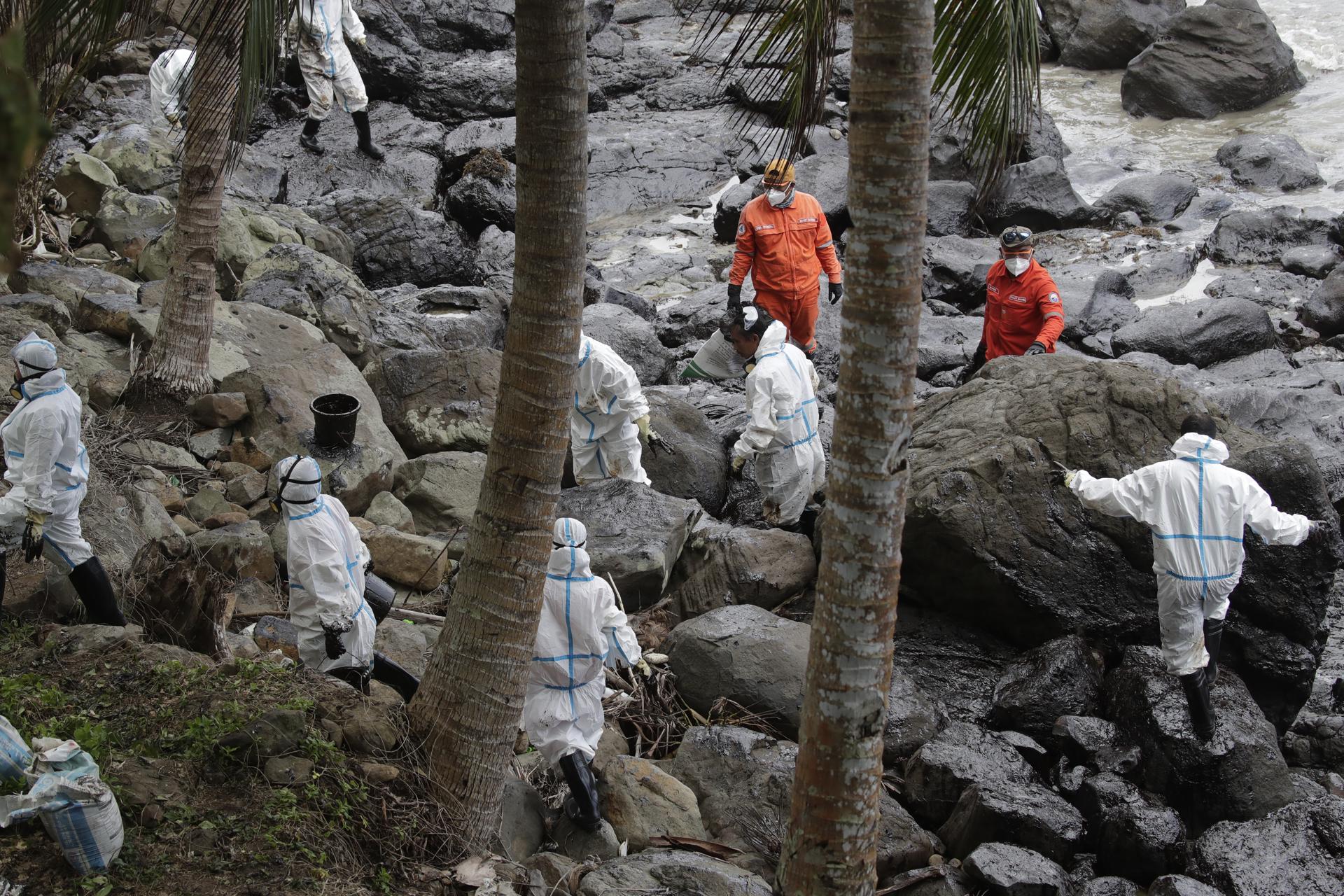 Filipino fishermen and coastguard personnel wearing protective suits collect oily waste along a beach in the coastal town of Pola, Mindoro island, Philippines, 06 March 2023. EFE/EPA/FRANCIS R. MALASIG