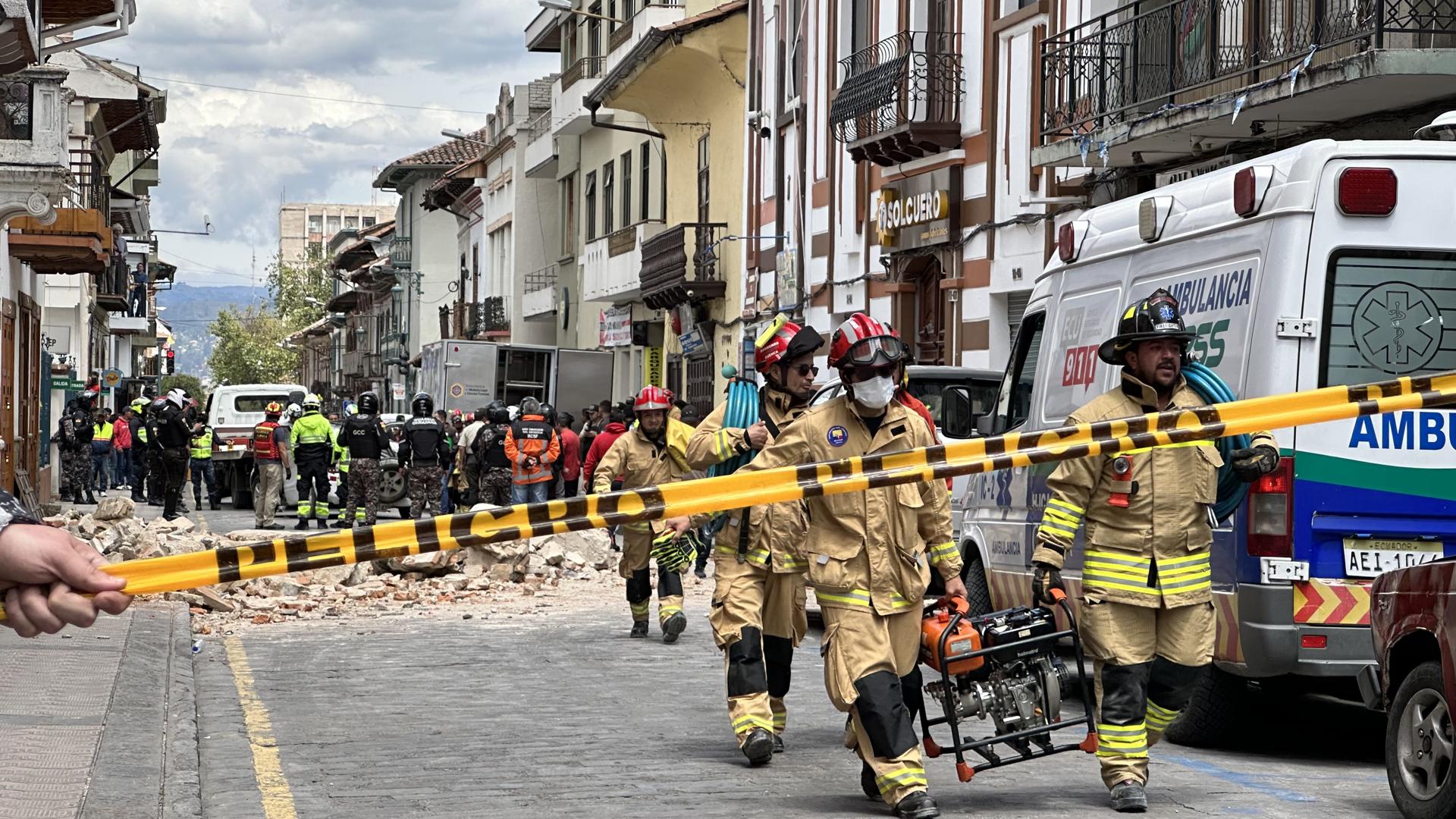 Firefighters help with the damage caused by the 6.5 magnitude earthquake in the city of Cuenca, Ecuador, 19 March 2023. EFE/Robert Puglla