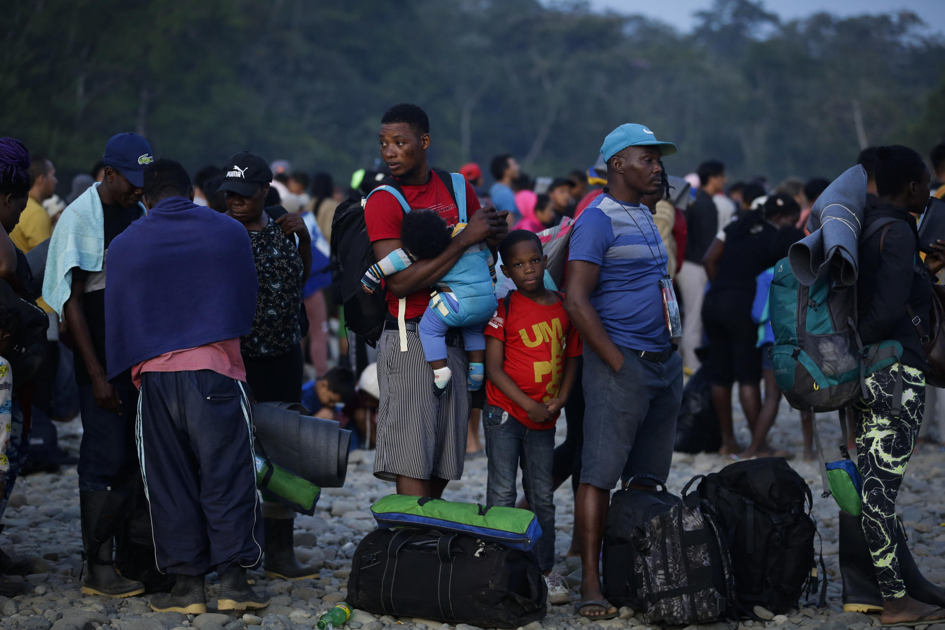 Migrants wait in the Panamanian town of Bajo Chiquito, from where they will be transported to the Panamanian government's Immigration Reception Station in Meteti, Panama, on March 11, 2023. EFE/ Bienvenido Velasco