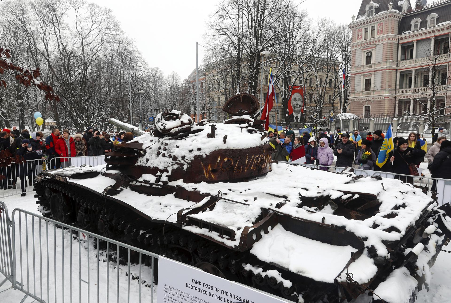 People look at a wrecked Russian T-728 tank, on display in front of Russian Embassy in Riga, Latvia, 24 February 2023. EFE-EPA/FILE/TOMS KALNINS