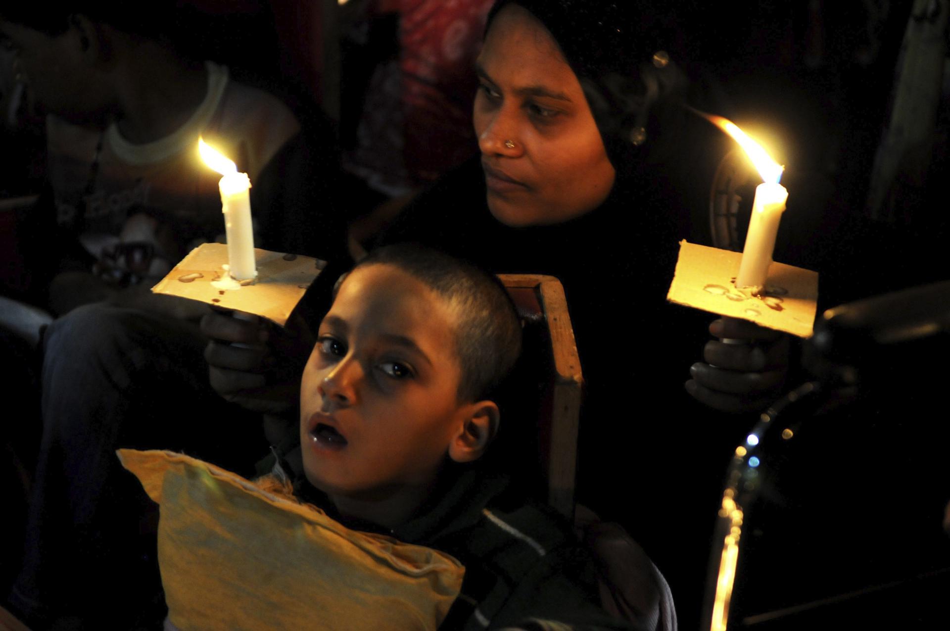 A child who was born with congenital deficiencies due to the leak of 42 tons of methyl isocyanate participates in a vigil in Bhopal, India December 1, 2015. EFE/File/Sanjeev Gupta