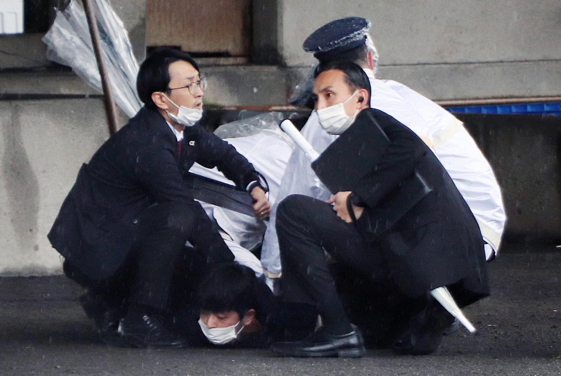 Police officers arrest a man suspected to have thrown explosives as Japanese Prime Minister Fumio Kishida was about to make a stump speech at a fishing port in Wakayama, Wakayama Prefecture, western Japan, 15 April 2023. EFE/EPA/JIJI PRESS JAPAN OUT EDITORIAL USE ONLY / ALTERNATE CROP
