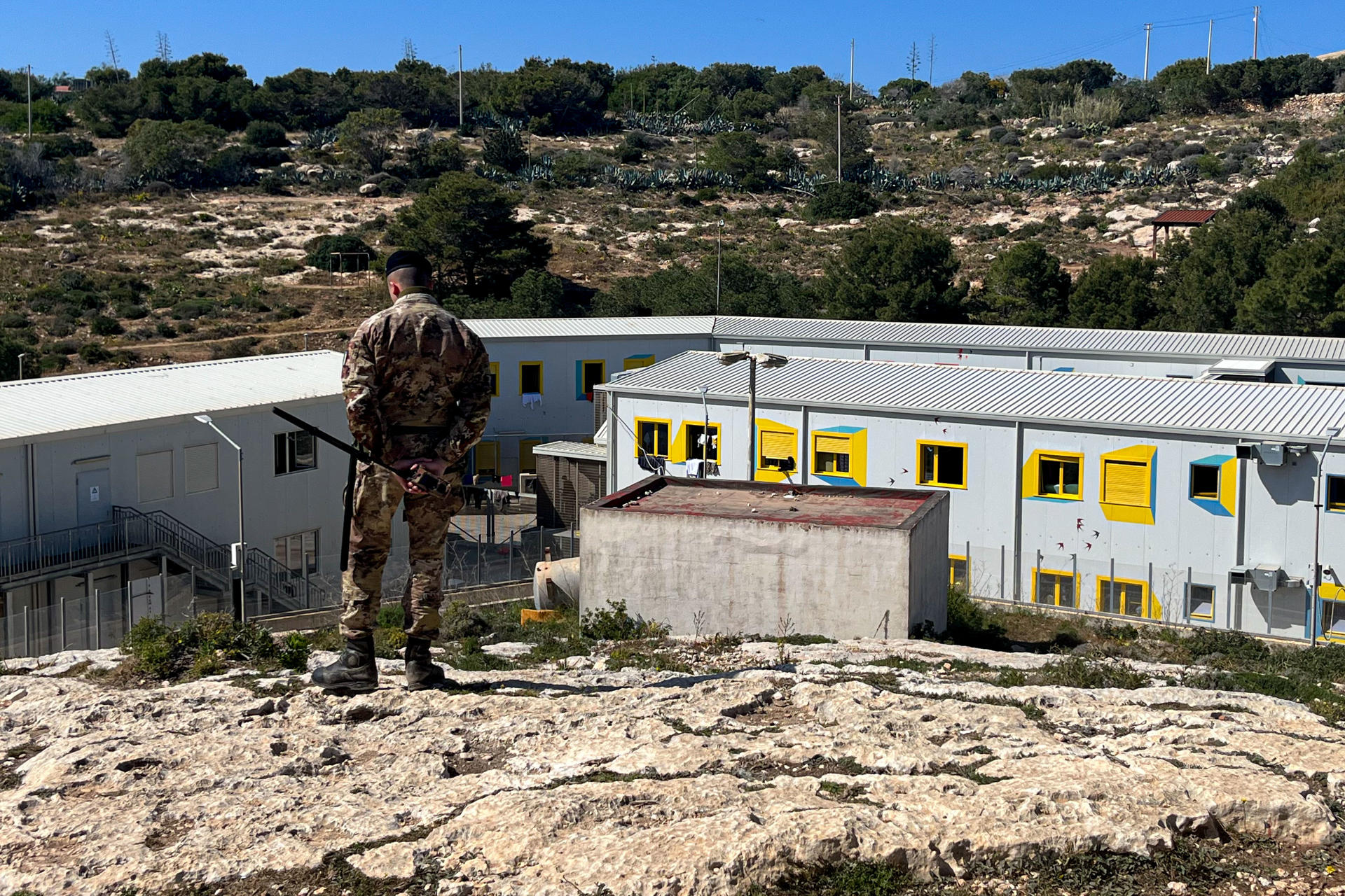An Italian Army soldier guards the only main reception center for migrants on the island of Lampedusa, Italy. EFE/Gonzalo Sanchez