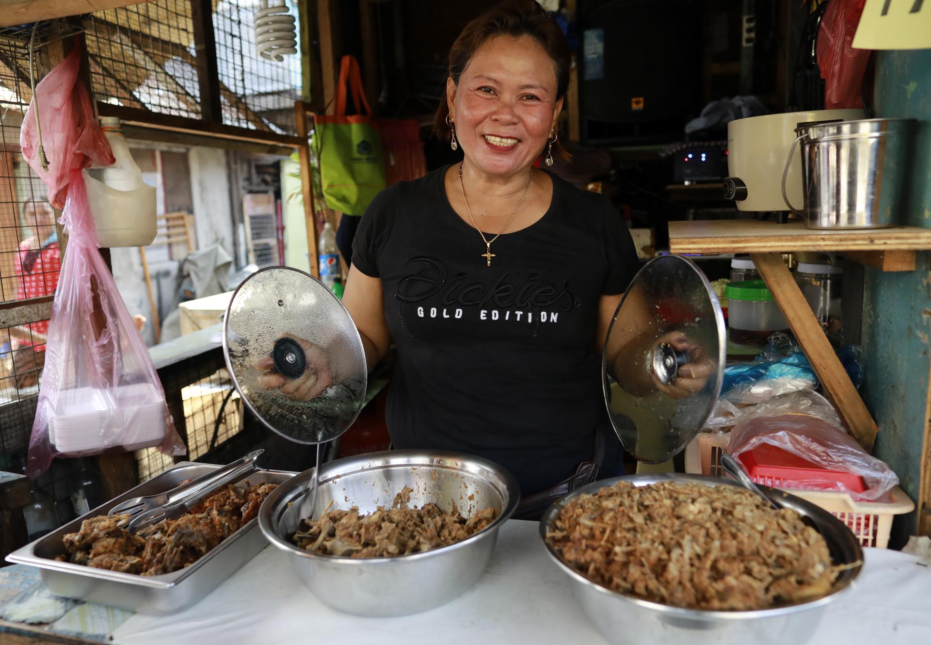 Filipino food vendor Evelyn Blasorca sells 'pagpag' in a slum area in Manila, Philippines, 21 April 2023 (issued on 24 April 2023). EFE/EPA/FRANCIS R. MALASIG