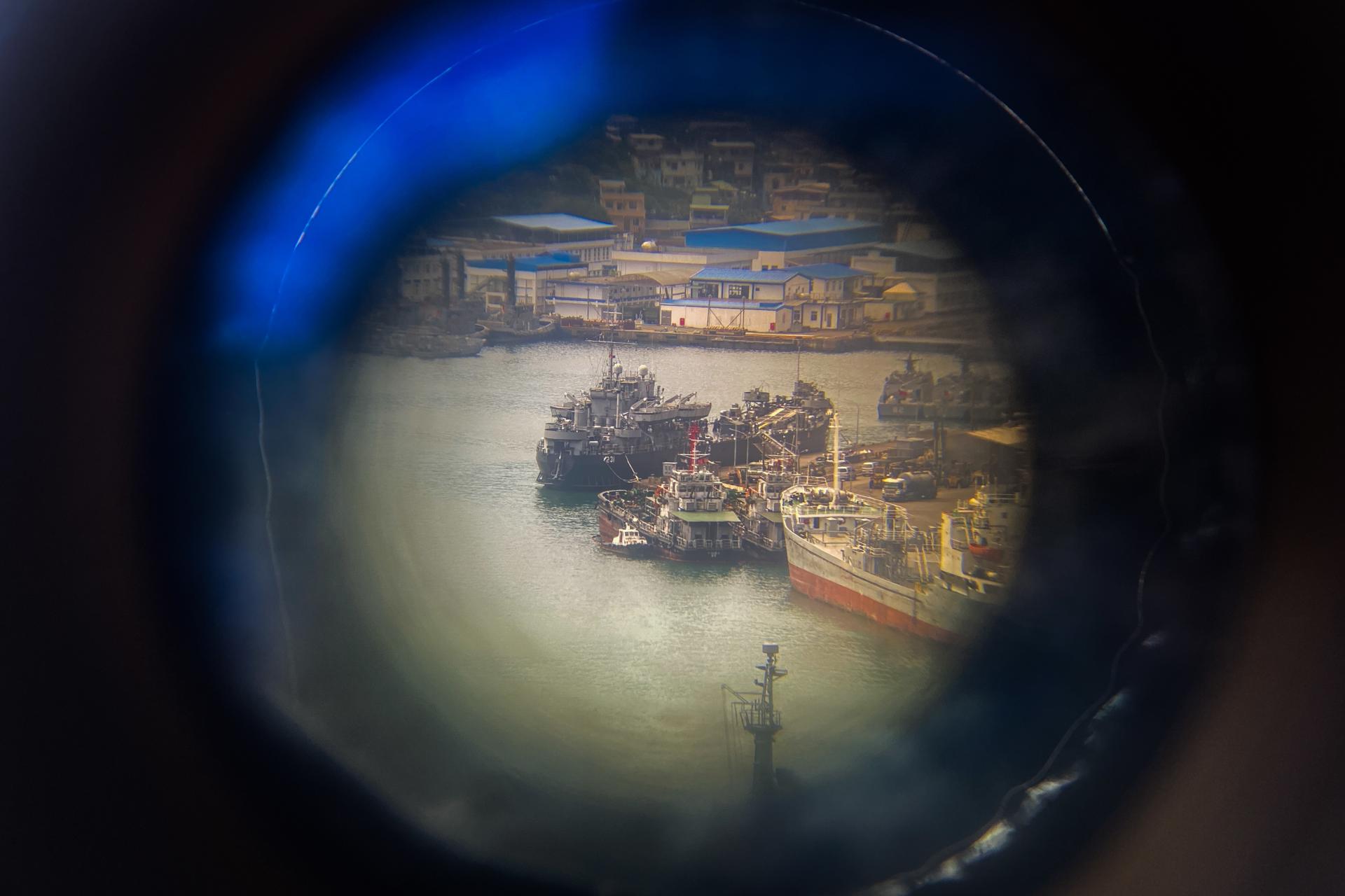 Taiwan Navy vessels are seen through a binocular as they are anchored in Keelung harbor in Keelung city, Taiwan, 10 April 2023. EFE/EPA/RITCHIE B. TONGO