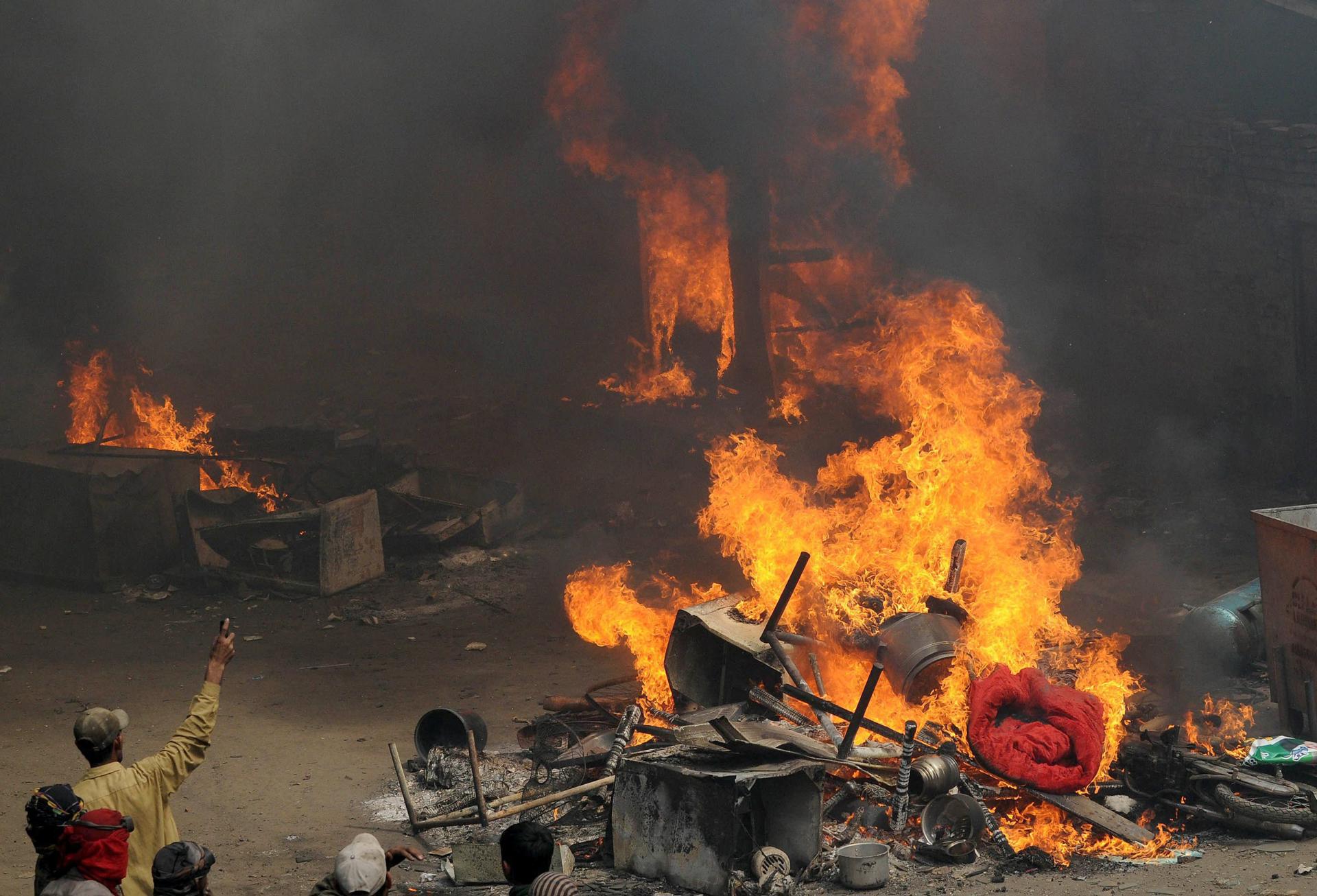 A file photo shows people destroying the belongings of a man after allegations of blasphemy in Lahore, Pakistan, 09 March 2013. EFE-EPA/File/RAHAT DAR