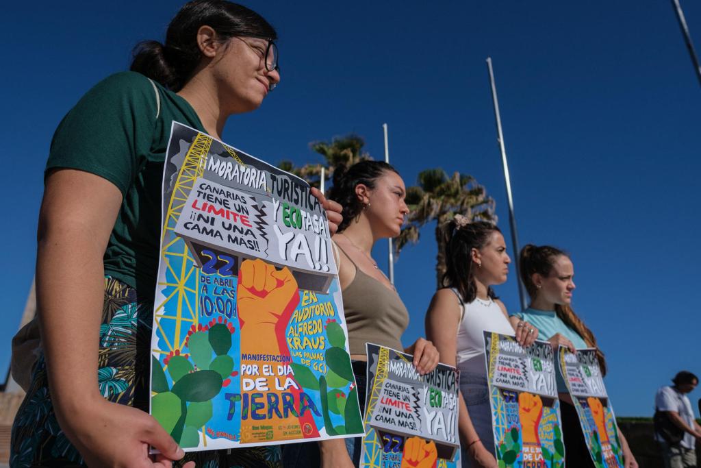 Young people from the Ben Magec-Ecologistas en Acción federation held this Saturday, on the occasion of Earth Day, a demonstration that toured the Las Canteras beach promenade, to claim the need to set limits to the mass tourism model in the Canary Islands.  EFE/Angel Medina G.