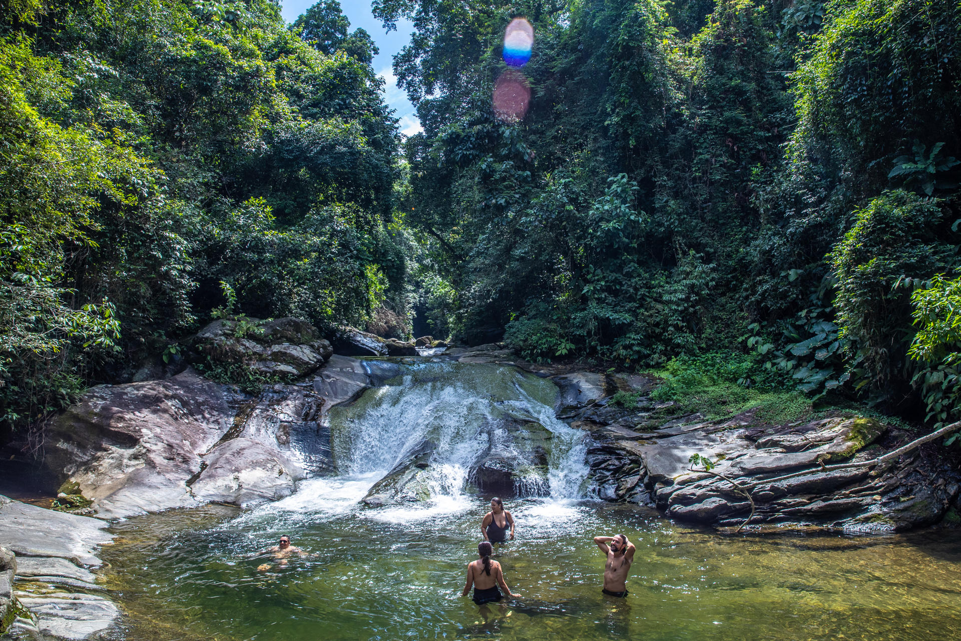 Tourists enjoys themselves in a waterfall in Guapimirim, Brazil, on 29 March 2023. EFE/Andre Coelho