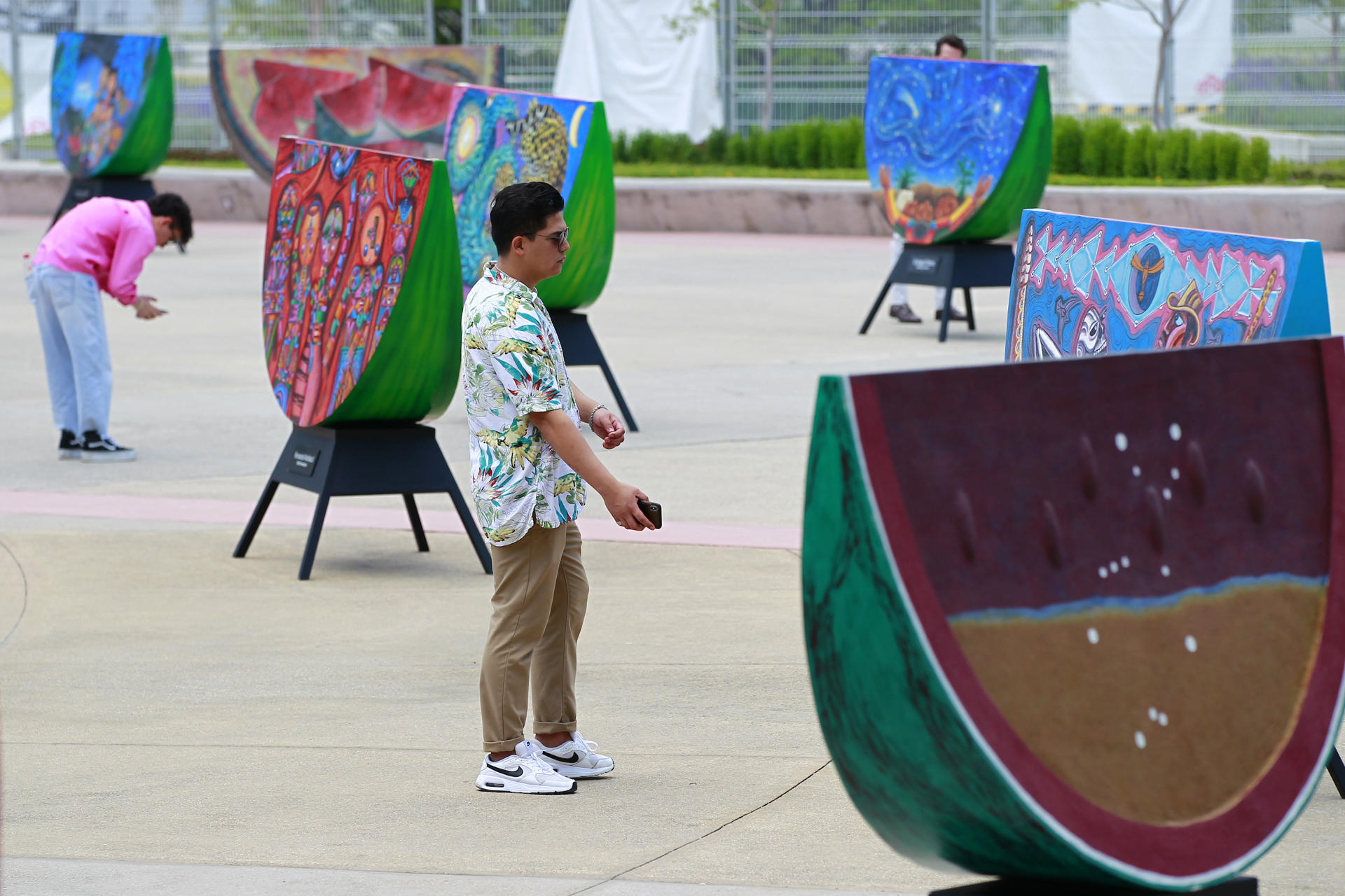 Visitors observe pieces of the exhibition "Watermelons and color: the legacy of Rufino Tamayo", on the esplanade of the Santander Performing Arts Complex in Guadalajara, Jalisco, Mexico, 17 April 2023 (issued 18 April 2023). EFE-EPA/Francisco Guasco
