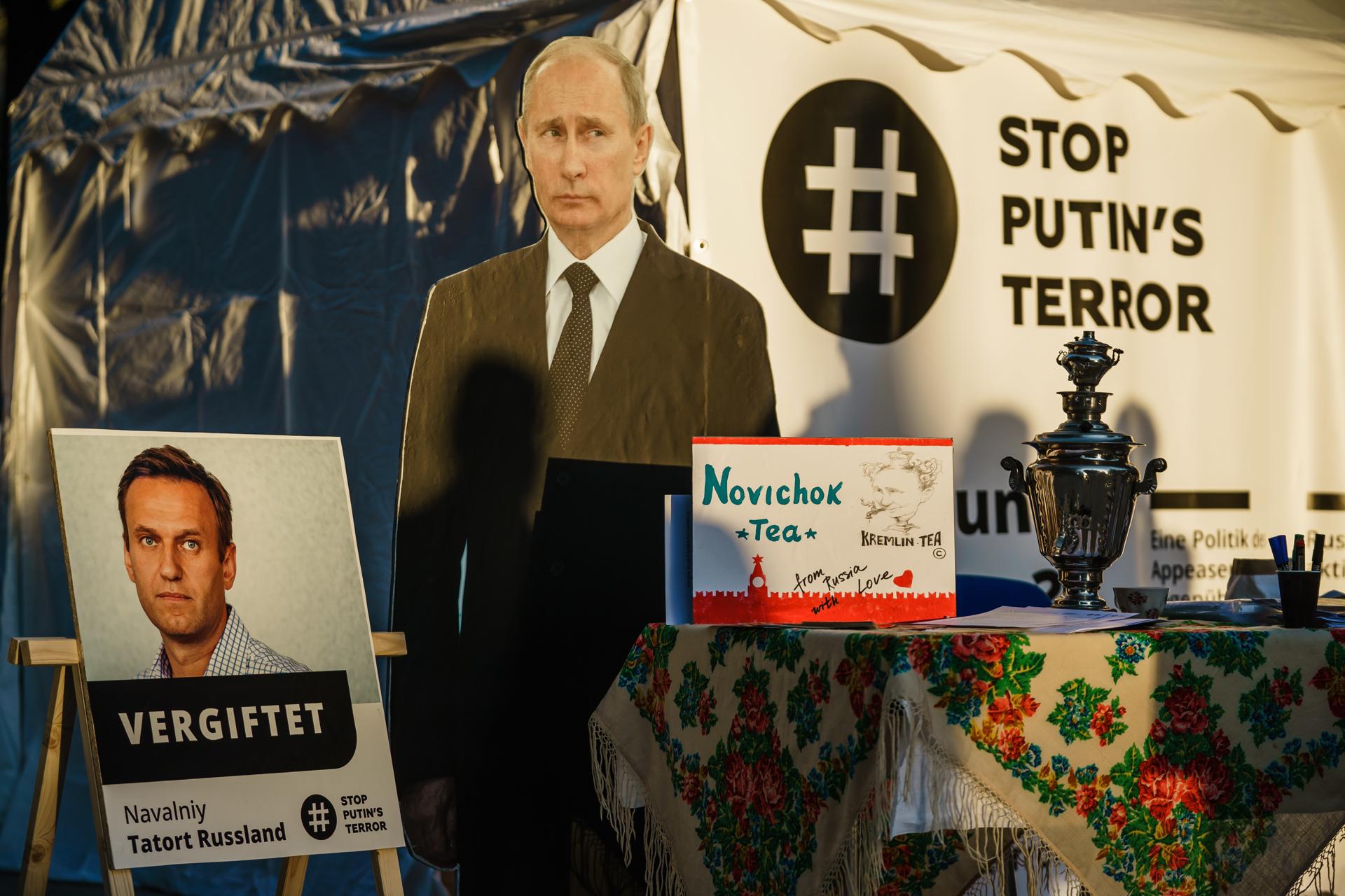 A file picture shows a protest demonstration in front of the Russian embassy with pictures of President Vladimir Putin and Russian opposition activist Alexei Navalny and a Russian teapot samovar with a note reading 'Novichok tea', 'Kremlin tea' and 'from Russia with love', in Berlin, Germany, 16 September 2020. EFE-EPA/FILE/CLEMENS BILAN