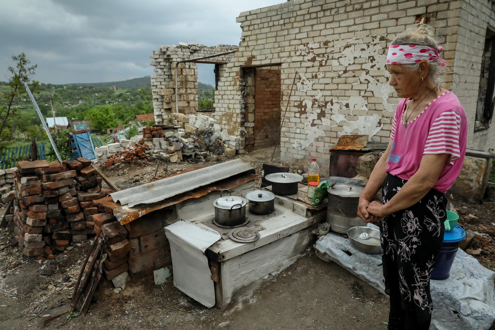 Lubov (67) stands on remains of her house, destroyed during the combat action, in Bohorodychne village, Donetsk region, 25 May 2023. EFE-EPA/OLEG PETRASYUK
