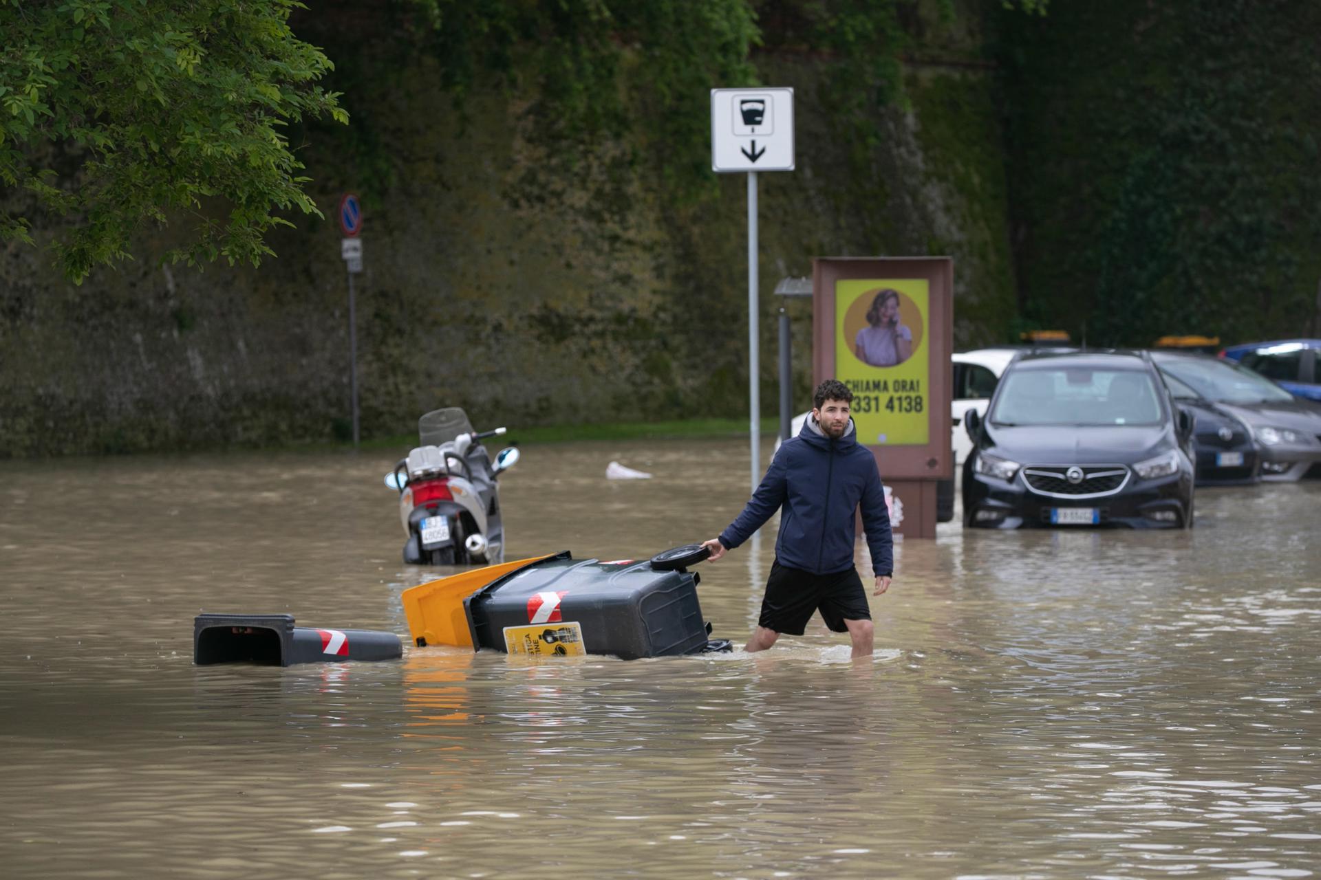 A man wades through flood water in Lugo, near Ravenna, Italy, 18 May 2023. EFE/EPA/EMANUELE VALERI