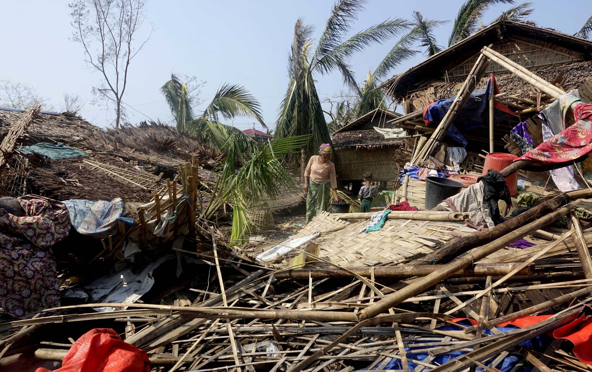 A Rohingya woman stands near a damaged house at the Thae Chaung Muslim internally displaced people (IDPs) camp near Sittwe, Rakhine State, Myanmar, 17 May 2023. EFE-EPA/STRINGER
