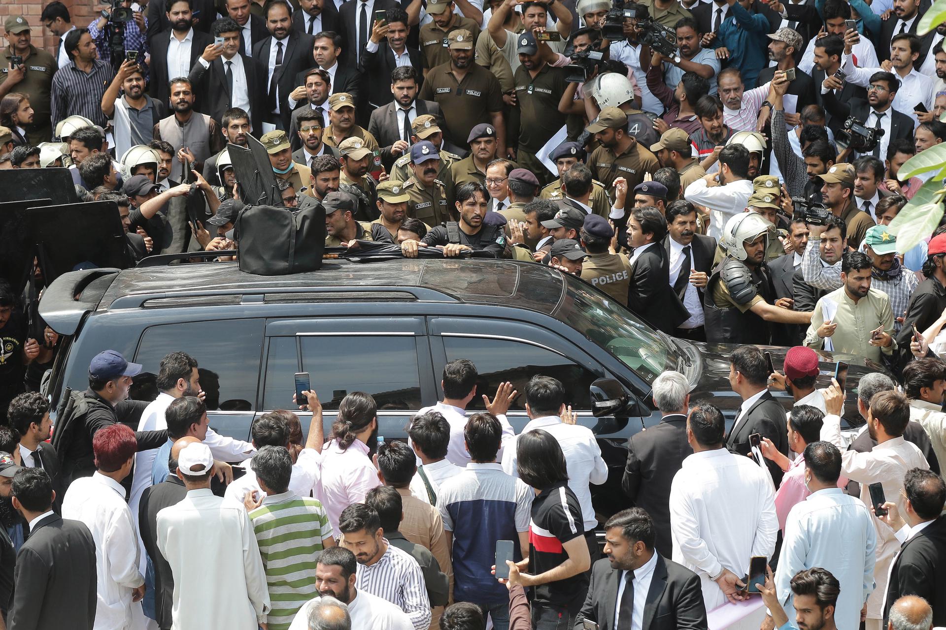 Private security personnel escort vehicle carrying former prime minister Imran Khan arriving at Lahore High Court to secure bail in cases registered against him, in Lahore, Pakistan, 30 May 2023. EFE-EPA/RAHAT DAR