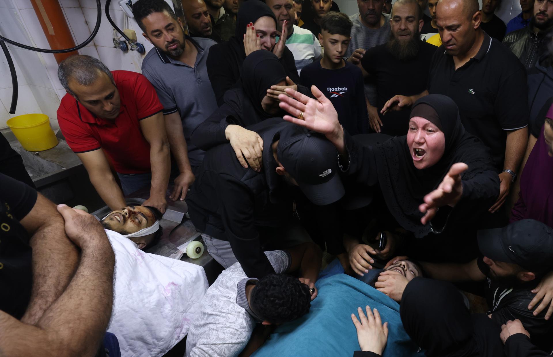 Palestinians react next to the bodies of their slain relatives at Rafedya Hospital, after they were killed during clashes with Israeli troops at Balata refugee camp near Nablus, in the West Bank, 22 May 2023. EFE-EPA/ALAA BADARNEH
