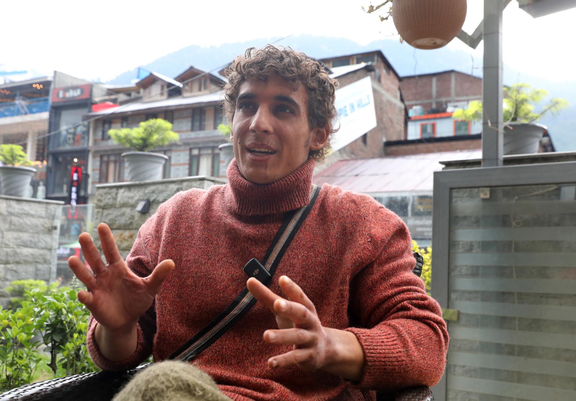 Spanish actor Miguel Herran (C) speaks during an interview at the shooting of the movie 'Valle de Sombras' (Valley of Shadows) at a market in Manali, Himachal Pradesh, India, 18 May 2023 (Issued 25 May 2023). EFE/EPA/RAJAT GUPTA