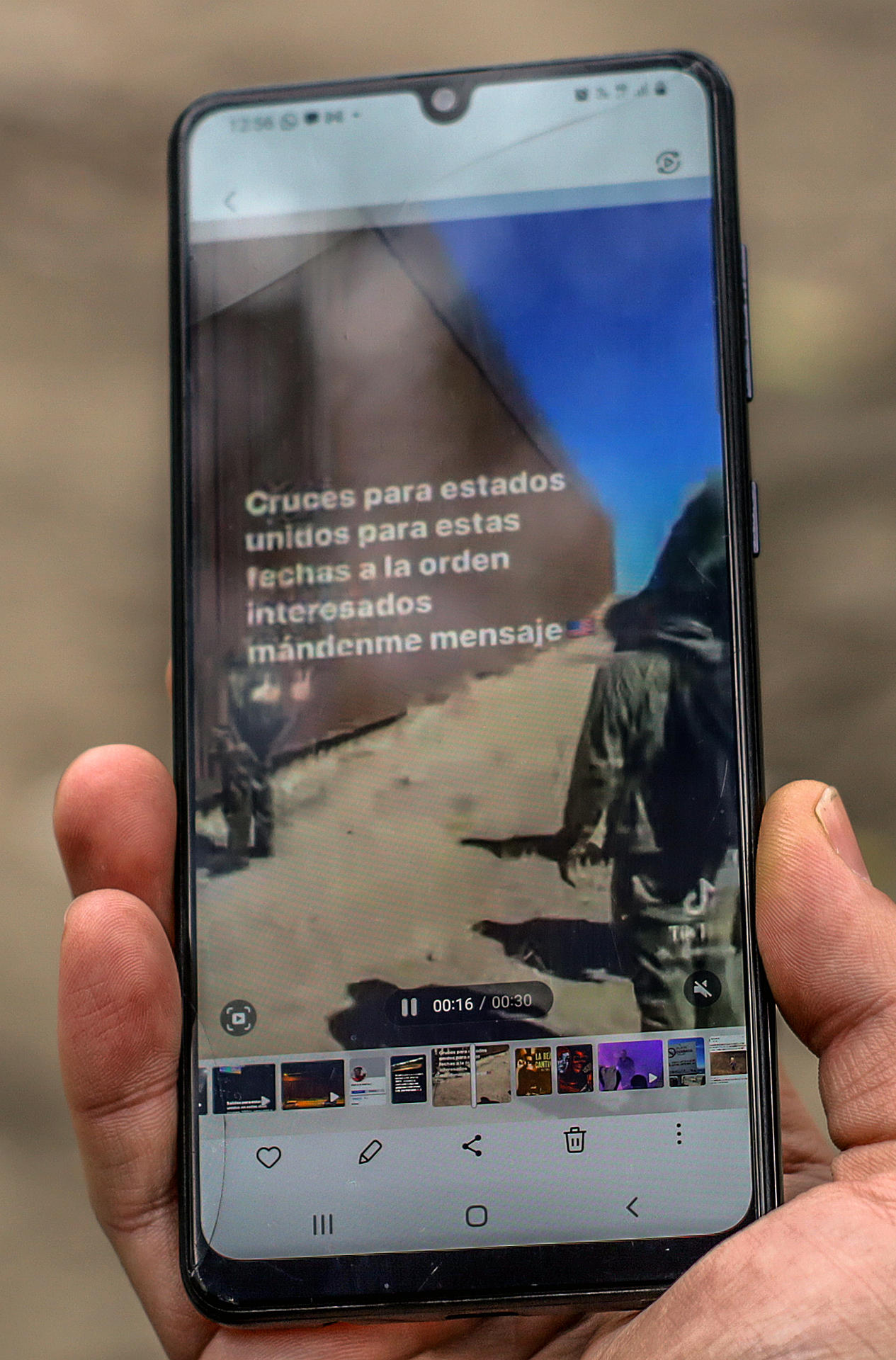 Detalle de la pantalla de un teléfono en la que se ve un mensaje publicado en la red TikTok que ofrece el servicio de cruzar de manera ilegal hacia los Estados Unidos desde México.