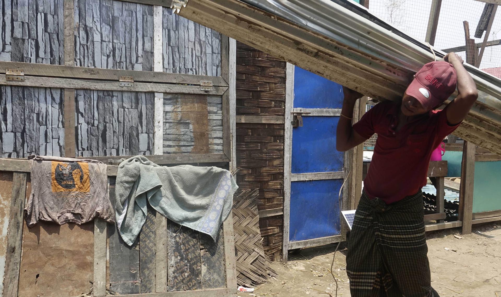 A Rohingya man repairs his house after cyclone Mocha hit ThetKel Pyin Muslim internally displaced people (IDPs) camp near Sittwe, Rakhine State, Myanmar, 20 May 2023. EFE-EPA FILE/STRINGER