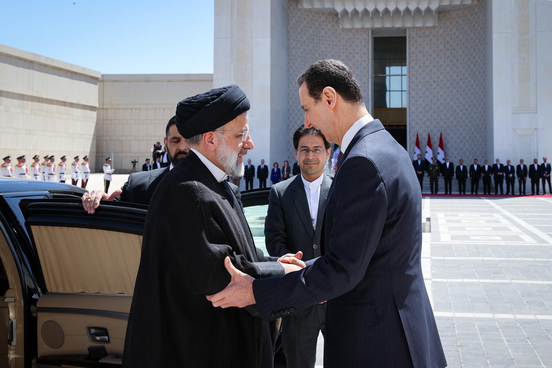 A handout photo made available by the Iranian presidential office shows Iranian president Ebrahim Raisi (L) and his Syrian counterpart Bashar Al Asad (R) during a welcome ceremony in Damascus, Syria, 03 May 2023. EFE/EPA/IRANIAN PRESIDENCY OFFICE