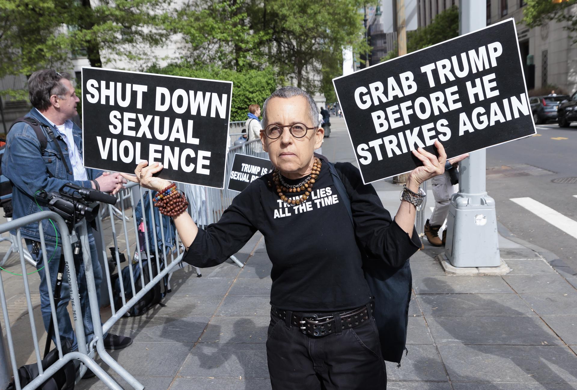 A supporter of E. Jean Carroll holds up signs outside a New York federal courthouse while awaiting the jury's verdict in Carroll's civil case against former President Donald Trump for sexual assault and defamation, on May 9, 2023. EFE/EPA/JUSTIN LANE
