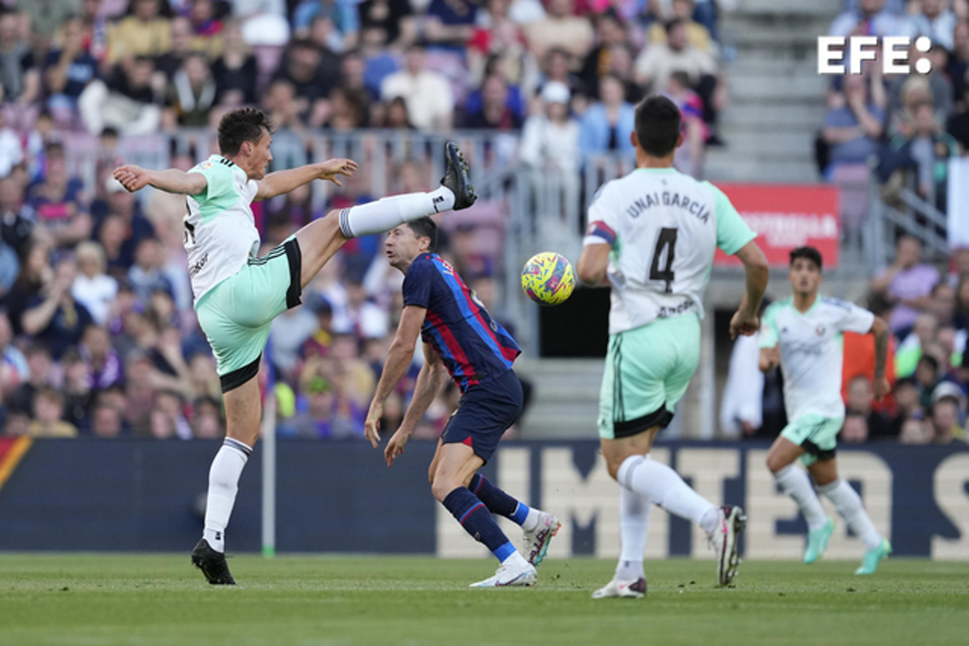 FC Barcelona's Robert Lewandowski (C) vies for the ball with Osasuna's Unai Garcia (R) and Juan Cruz during a LaLiga match at Spotify Camp Nou in Barcelona on 2 May 2023. EFE/Alejandro Garcia
