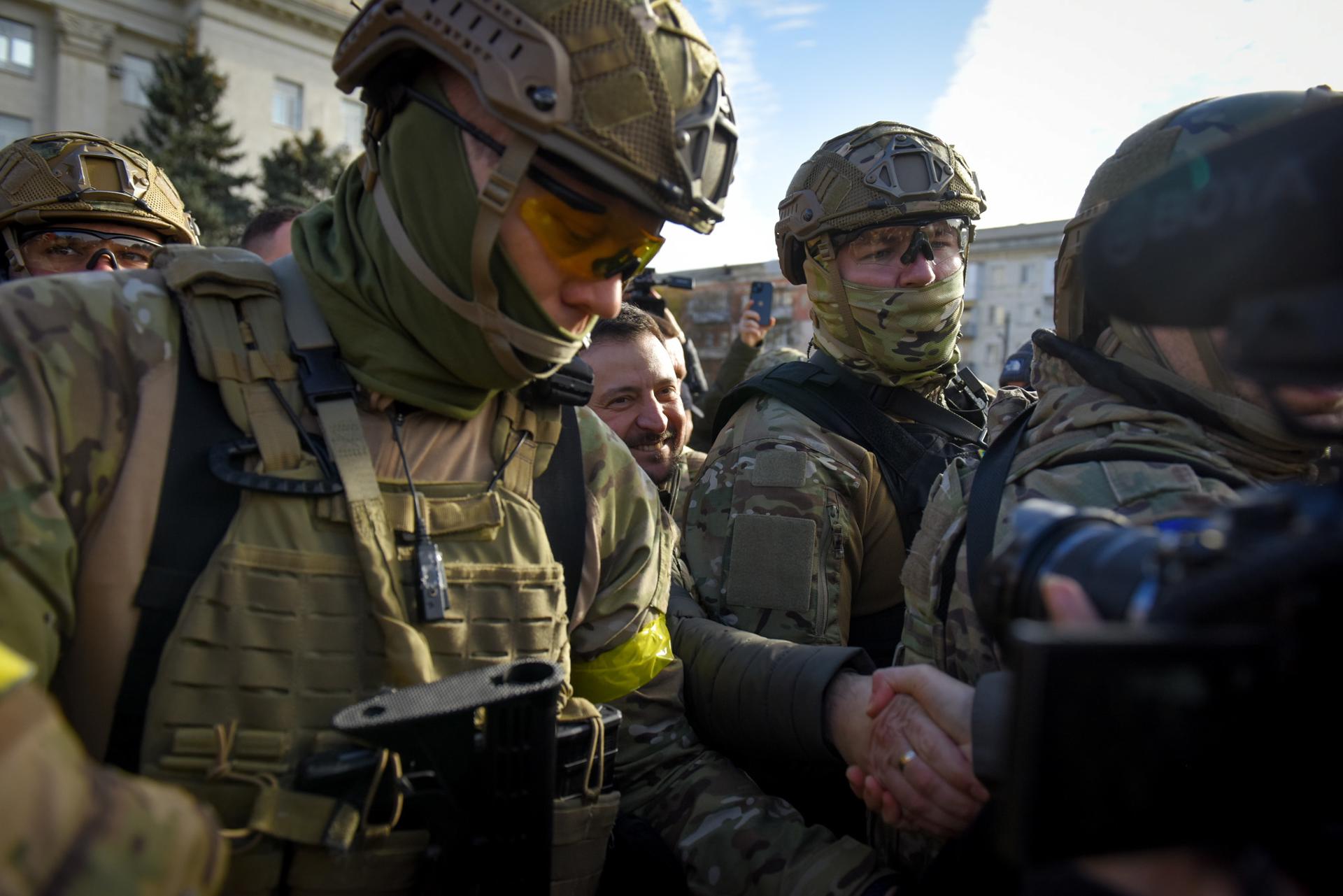 Ukrainian President Volodymyr Zelensky (C) is escorted by soldiers as he visits the recaptured city of Kherson, Ukraine, 14 November 2022. EPA-EFE/OLEG PETRASYUK