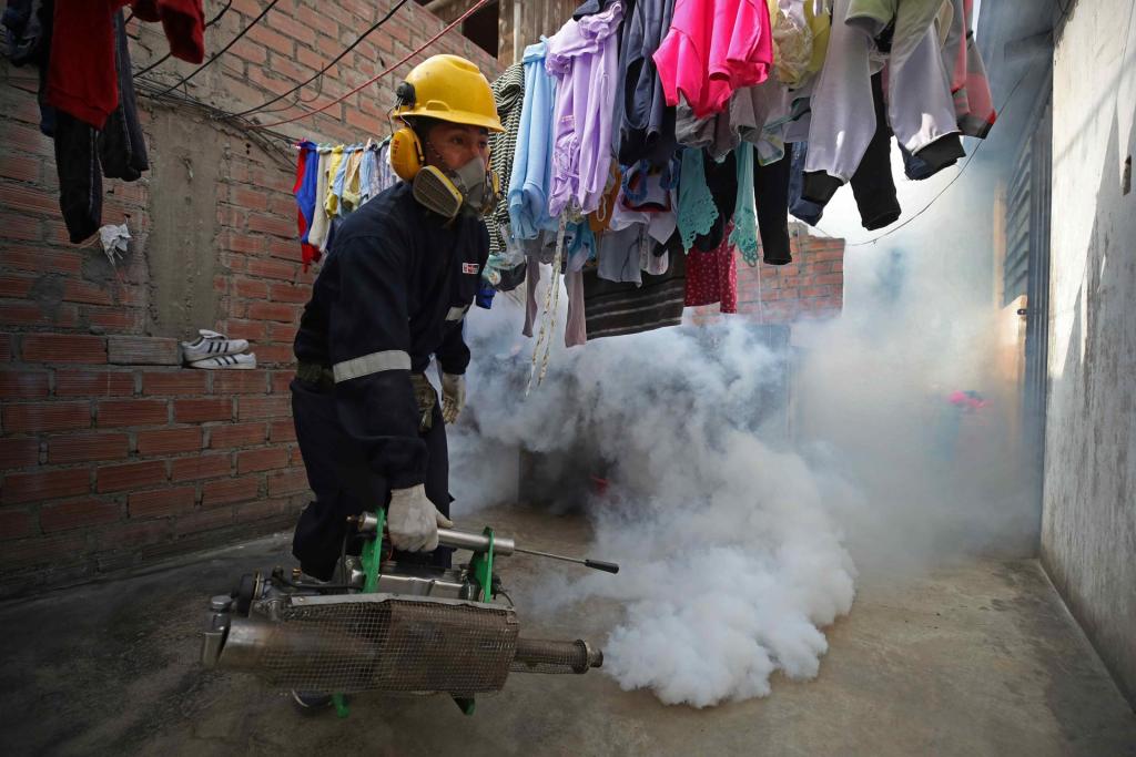 A worker sprays a house in the El Agustino district as a preventive measure against dengue fever, on May 16, 2023, in Lima, Peru.  EFE/Paolo Aguilar
