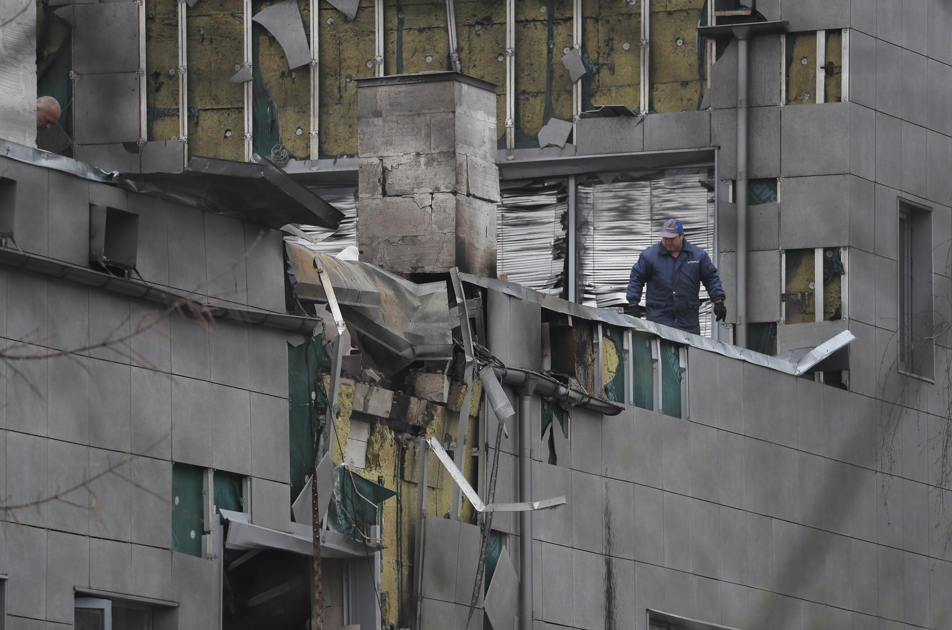 Workers clean debris at the site of a downed attack drone, in a residential area of Kyiv, Ukraine, 28 March 2023. EFE-EPA FILE/SERGEY DOLZHENKO