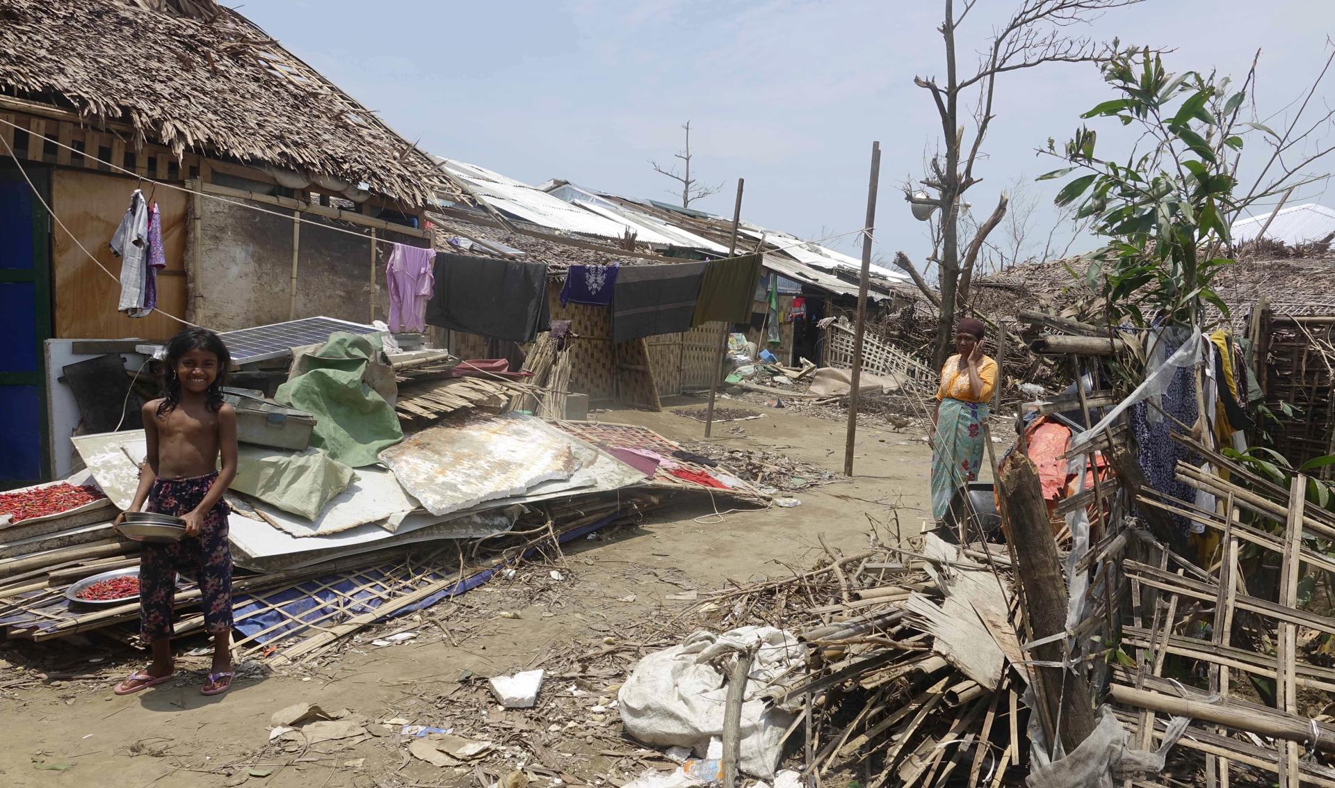 Rohingya woman and a girl stand near their house after cyclone Mocha hit ThetKel Pyin Muslim internally displaced people (IDPs) camp near Sittwe, Rakhine State, Myanmar, 20 May 2023. EFE-EPA FILE/STRINGER
