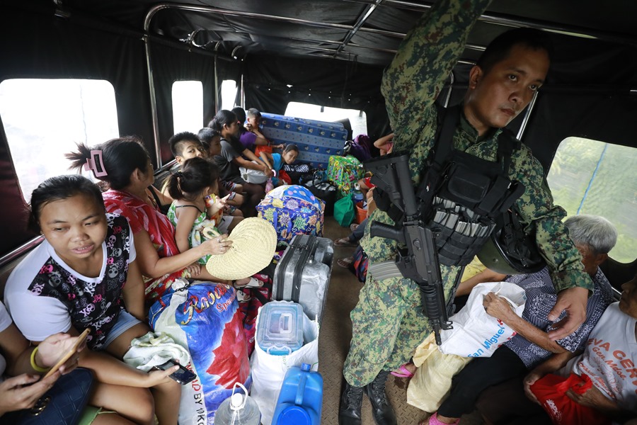 Filipinos living at the foot of the Mayon Volcano are evacuated in a military vehicle in Guinobatan City, Albay Province, Philippines