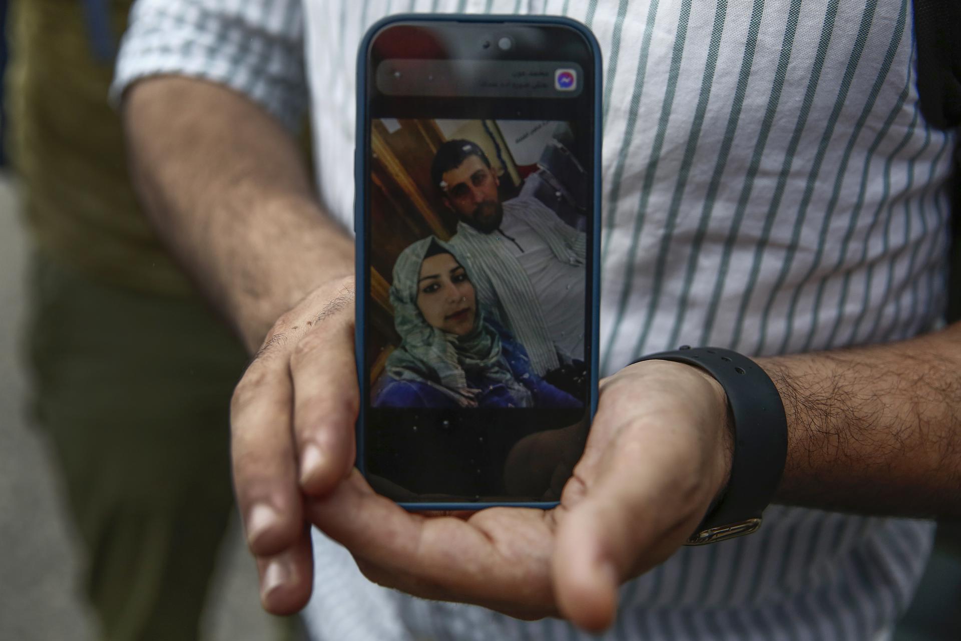 Kassem Abo Zeed, 34, from Syria, holds up a photo on his mobile of his missing wife Israa who were on the ship with refugees and migrants that sank off Pylos, in the port of Kalamata, southwest of Athens, Greece, 15 June 2023. EFE/EPA/YANNIS KOLESIDIS