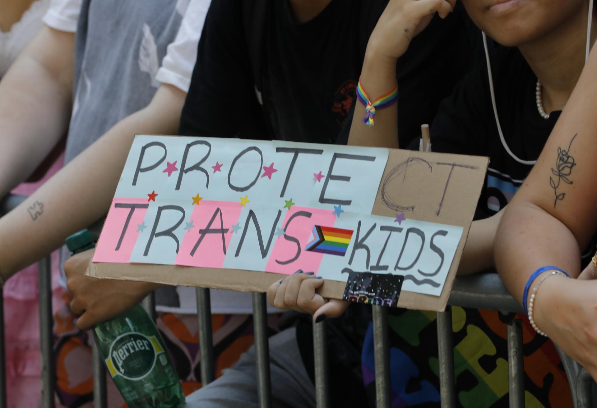 A person holds up a sign reading "Protect Trans Kids" at the LGBTQ+ Pride march in New York on 25 June 2023. EFE/EPA/Peter Foley