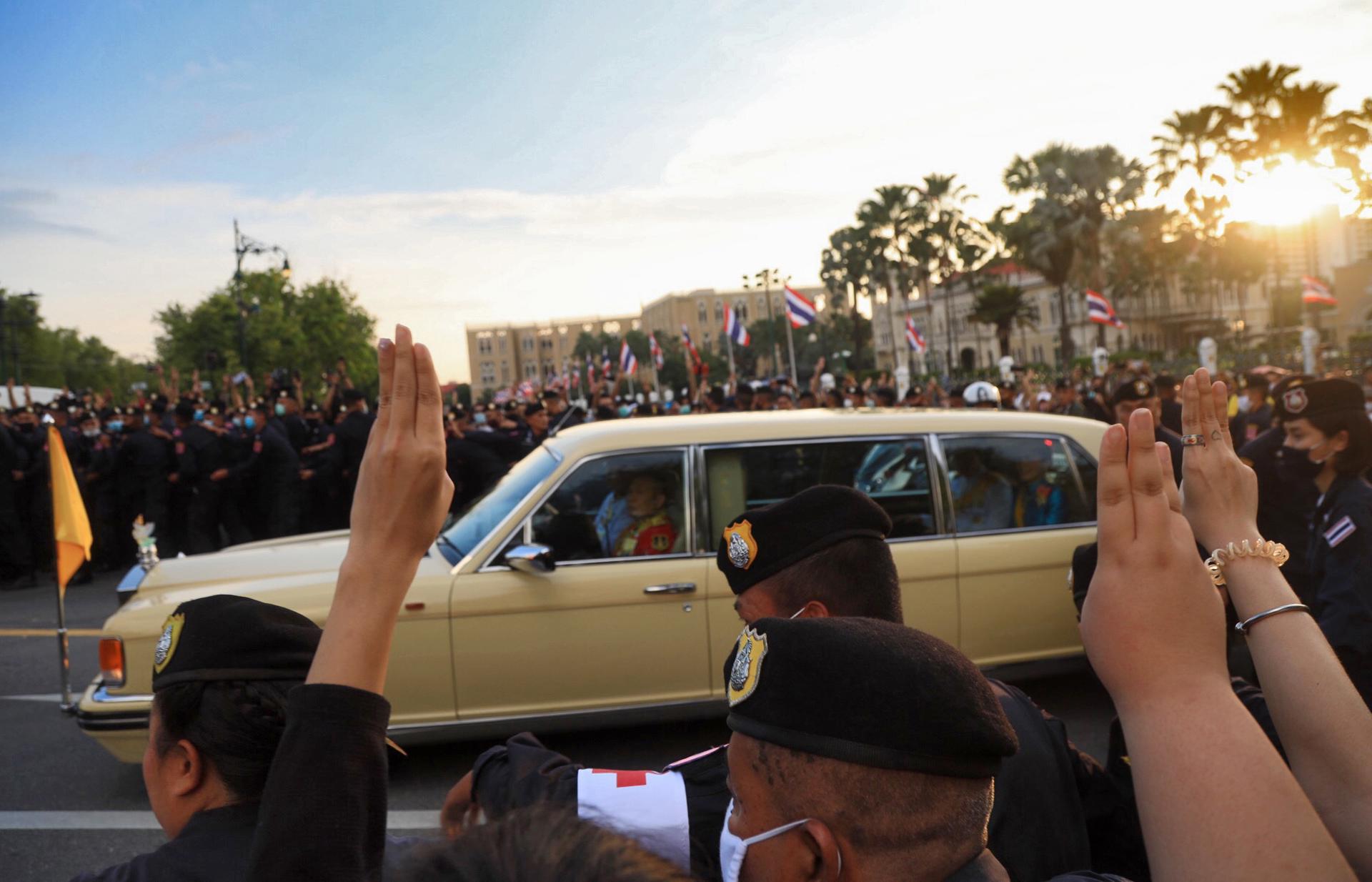 (FILE) Thai protesters flash the three-finger salute as the motorcade carrying Thailand's Queen Suthida drive past during an anti-government protest in Bangkok, Thailand, 14 October 2020. EFE/EPA/STR