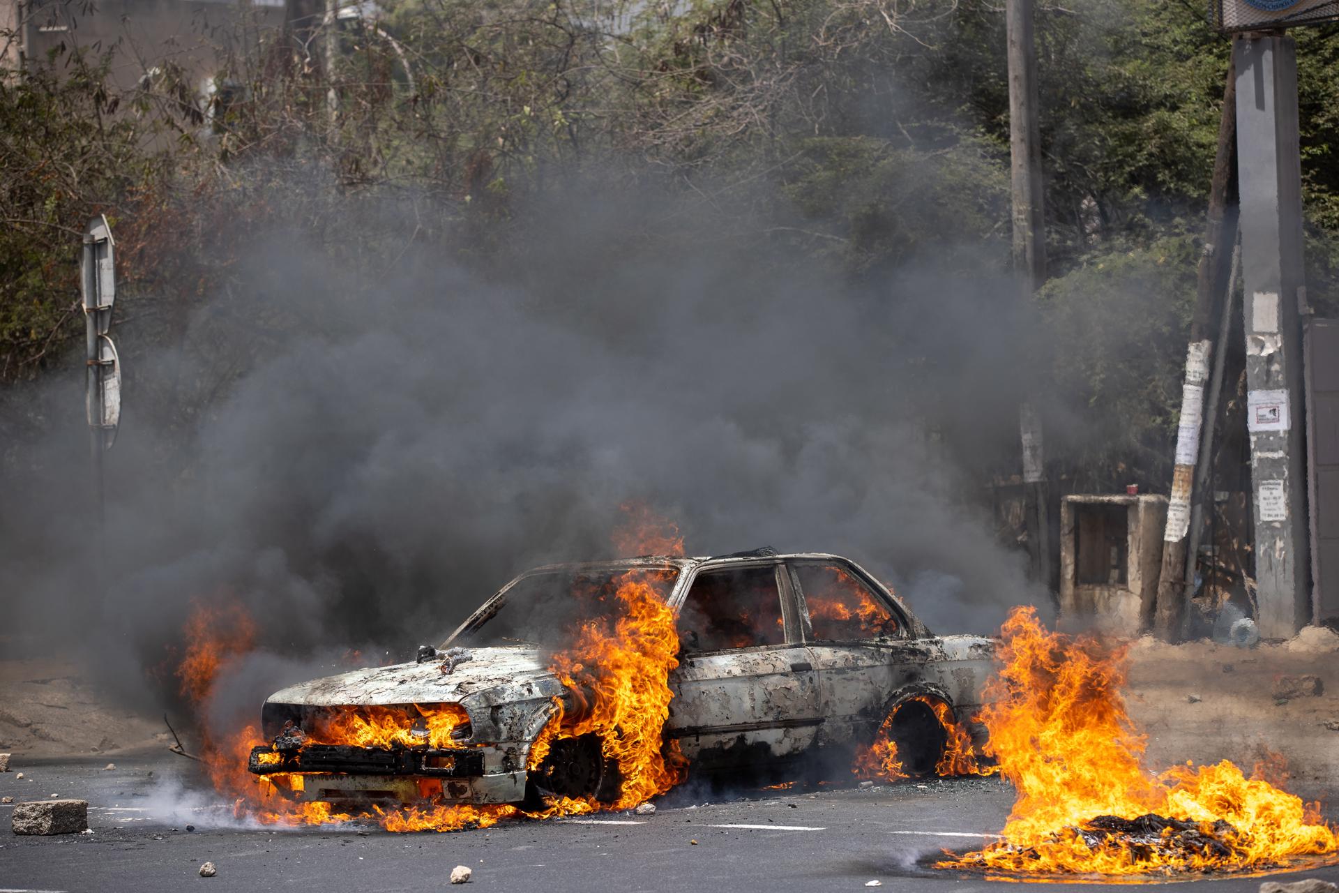 A car burns after being set on fire by protesters outside Cheikh Anta Diop University in Dakar, Senegal, 01 June 2023. EFE-EPA/JEROME FAVRE