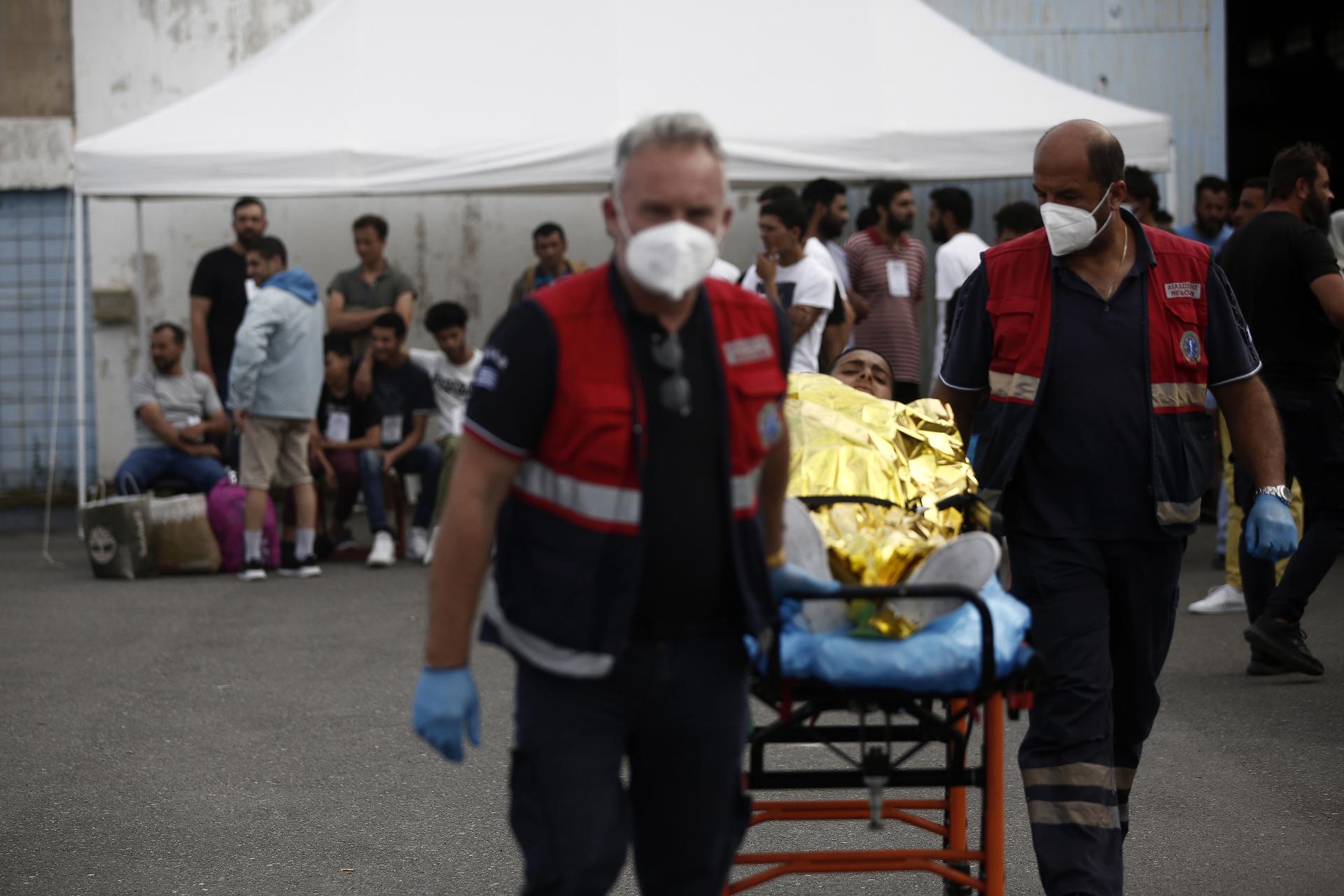 Paramedics of the Greek National Emergency Ambulance Service (EKAV) transfer a migrant to their ambulance, in Kalamata, Greece, 16 June 2023.EFE/EPA/YANNIS KOLESIDIS
