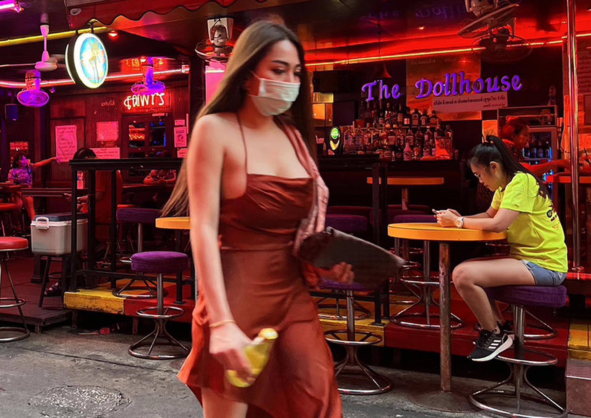 An employee (R) waiting for customers in front of a night bar at Soi Cowboy, a red light district in Bangkok, Thailand, 21 June 2023. EFE-EPA/NARONG SANGNAK