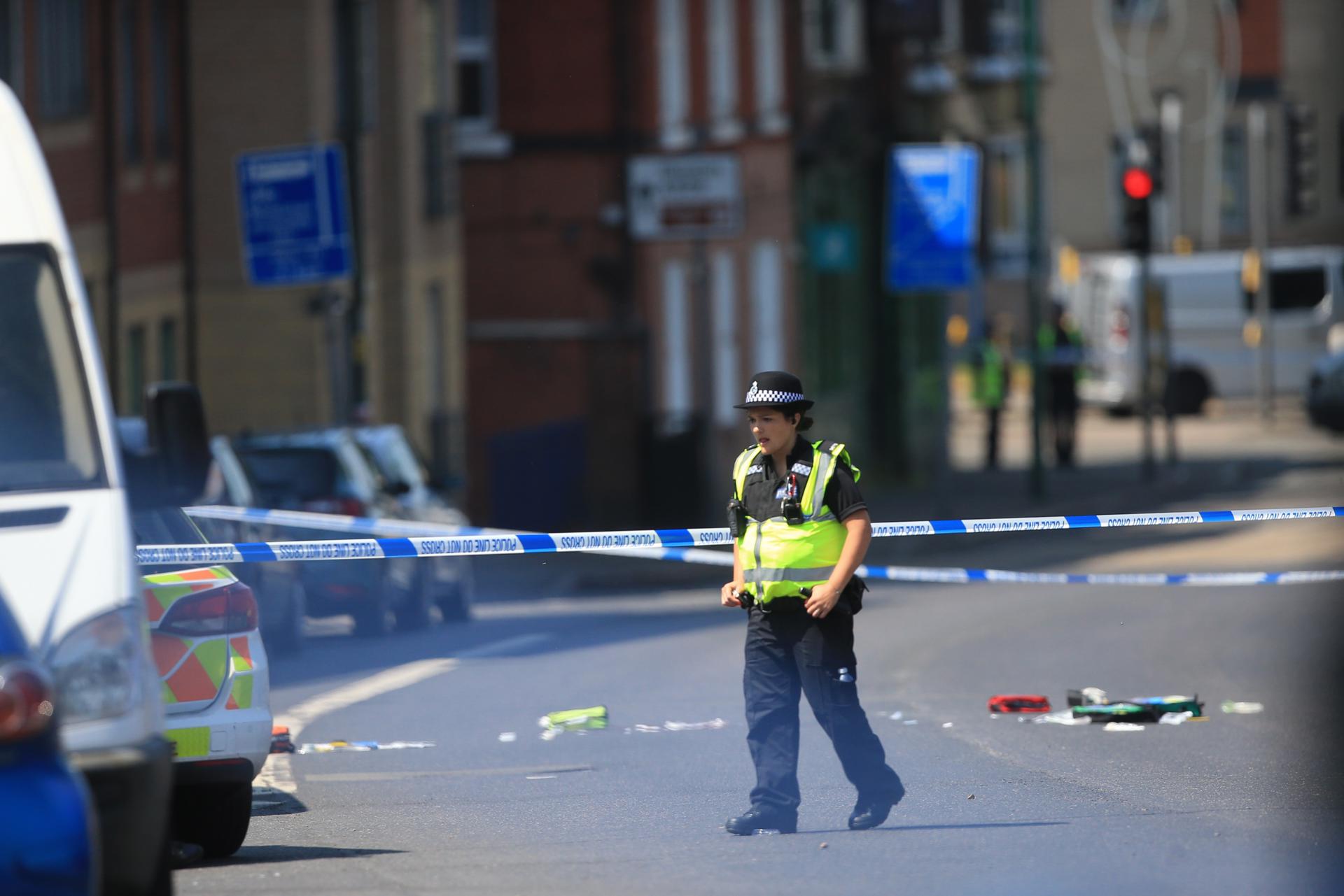 A police officer on the scene in Ikleston Road in Nottingham, Britain, 13 June 2023, where three people have been found dead following what police describe as an 'horrific and tragic incident'. EFE/EPA/LINDSEY PARNABY